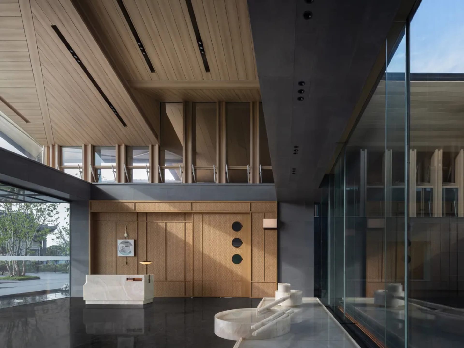 The interior of a modern lobby featuring wooden walls and marble floor.