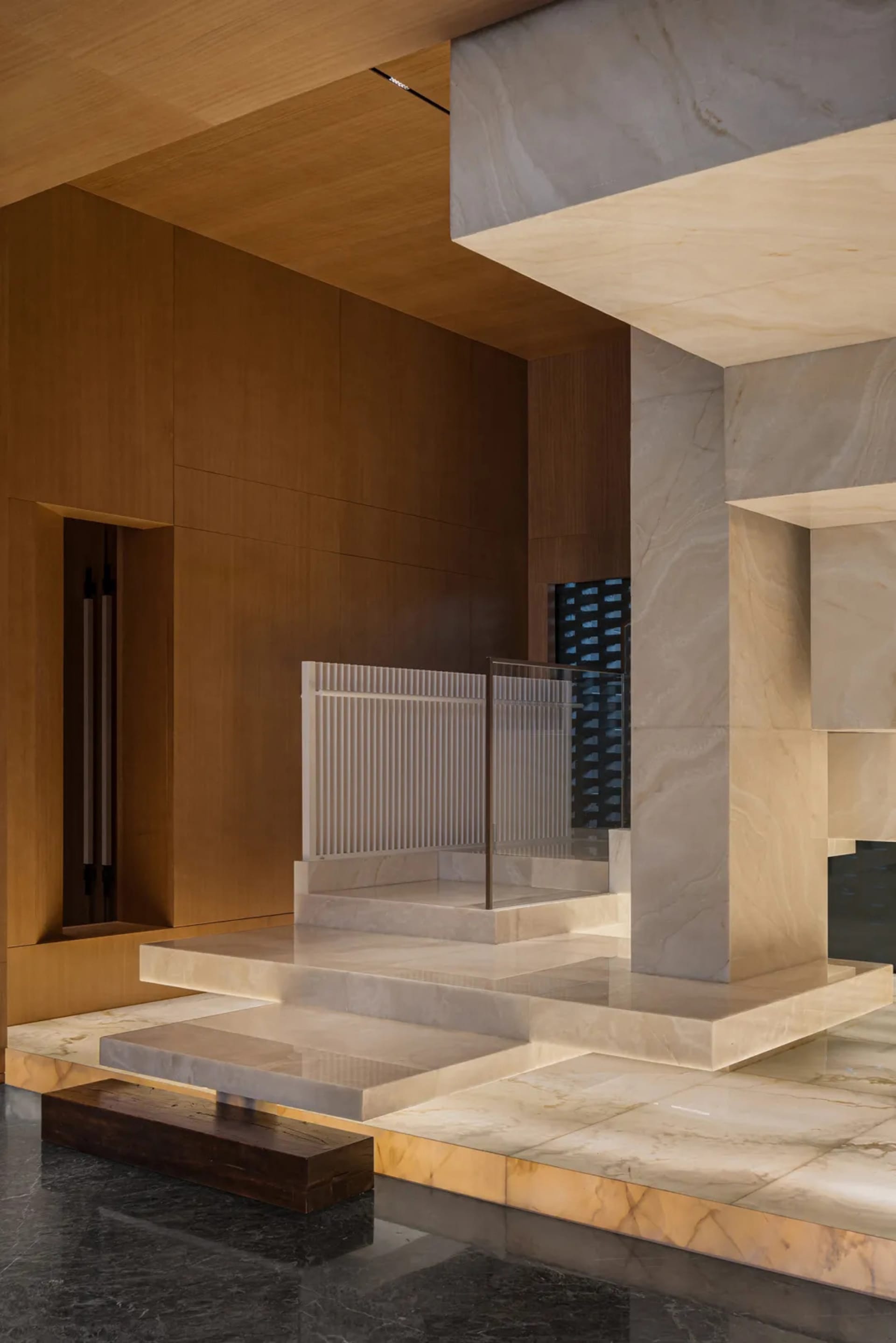 A modern lobby featuring marble elements and architectural design details.