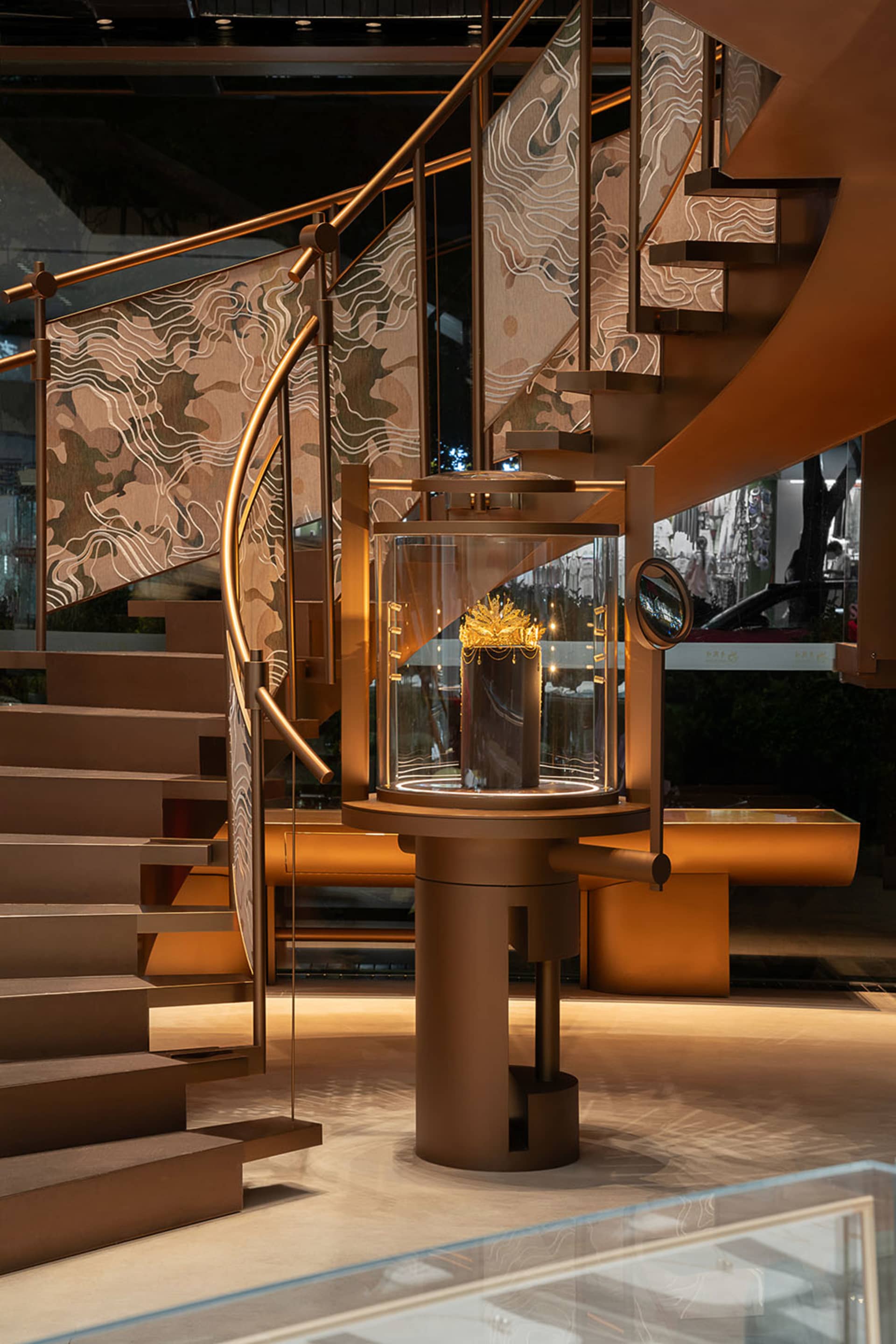 Modern retail shop featuring metal railings and a glass display case.