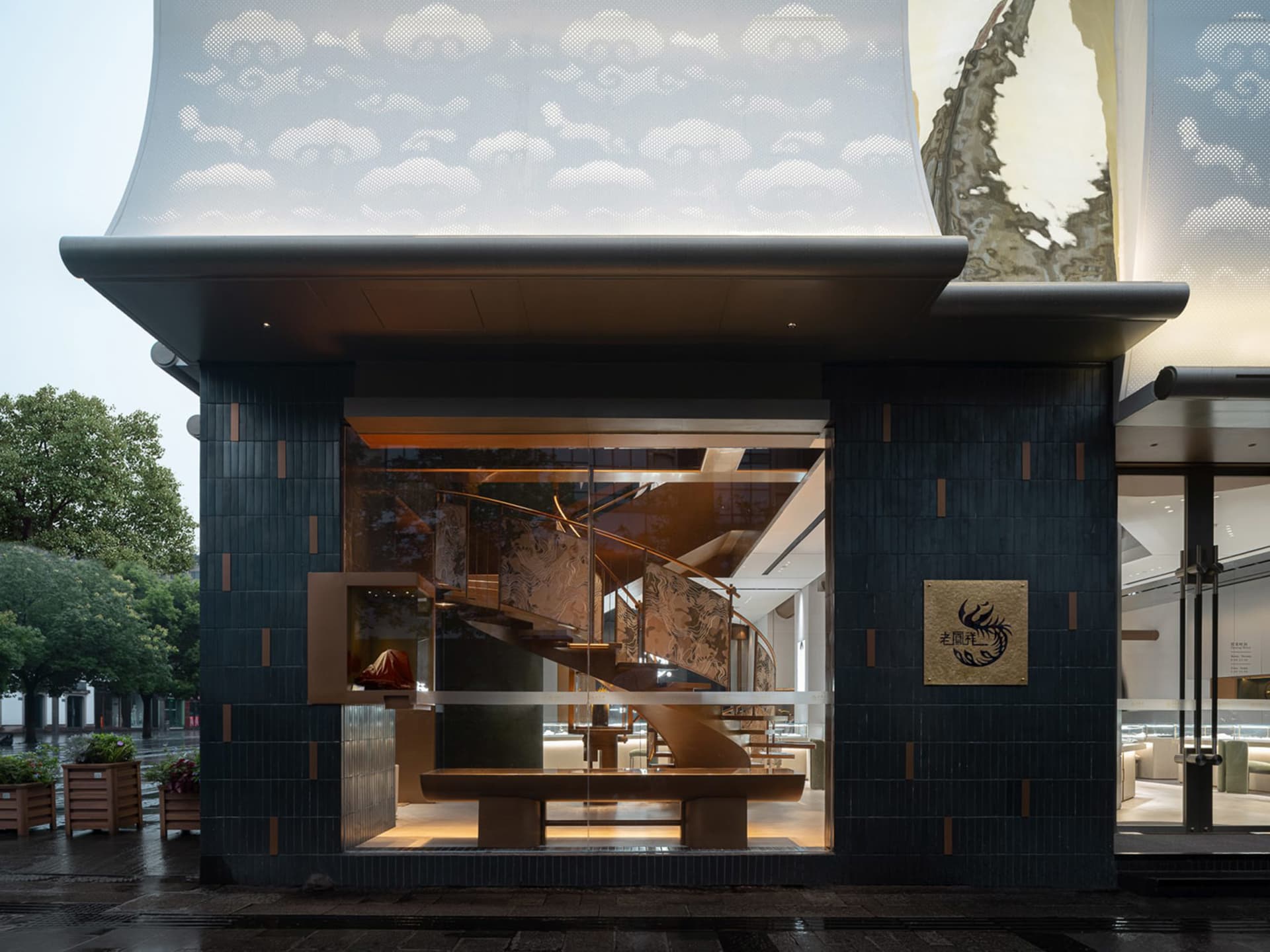 Modern retail storefront with metal cladding and concrete exterior.
