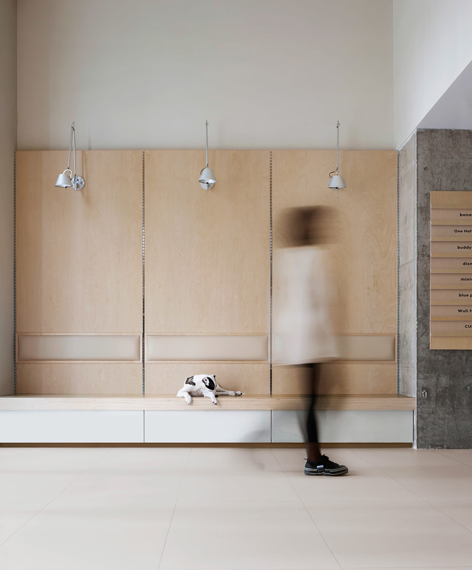 A minimalist living space featuring wooden, concrete, and metallic surfaces.