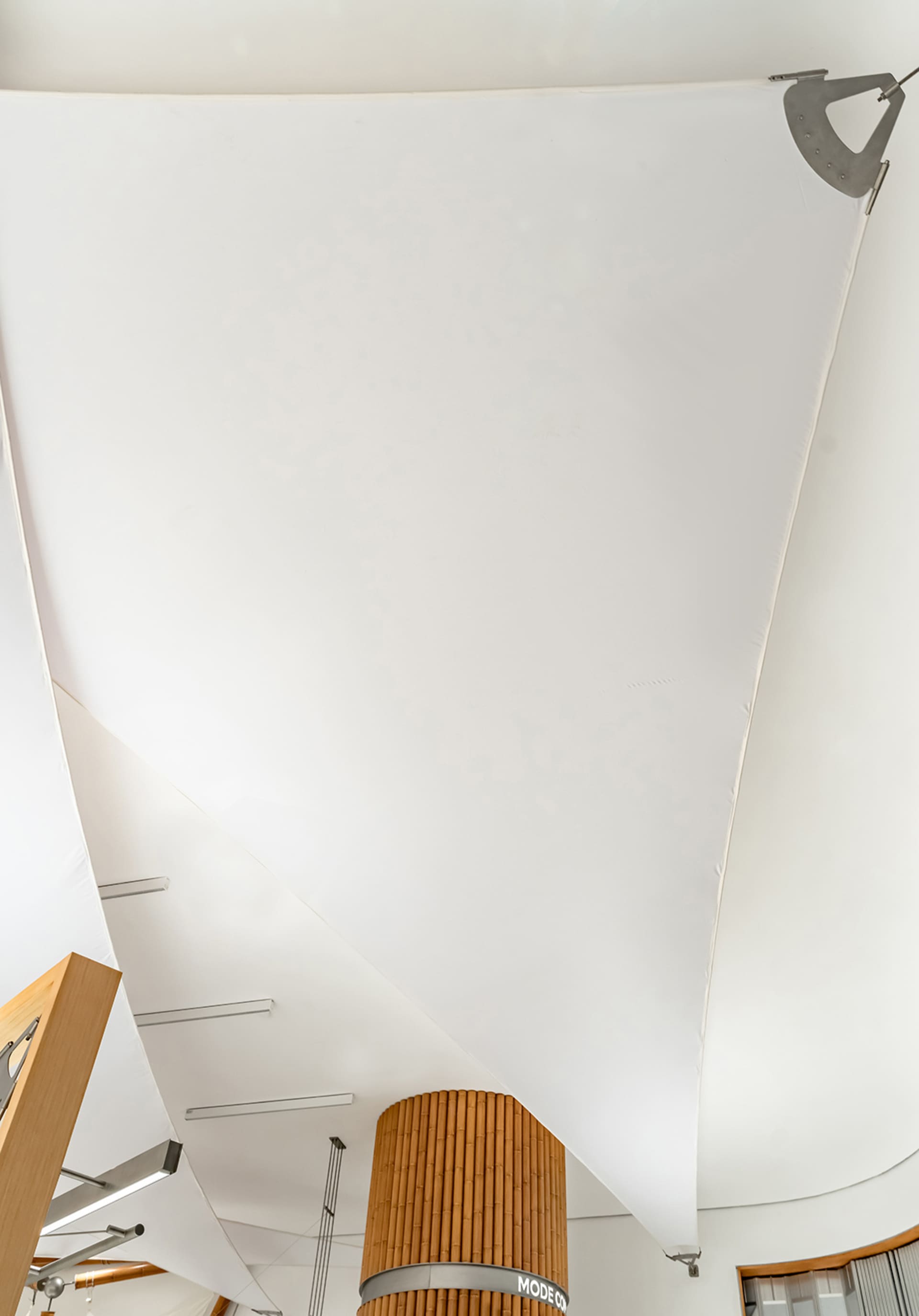 A modern interior design featuring a metallic pendant light fixture.