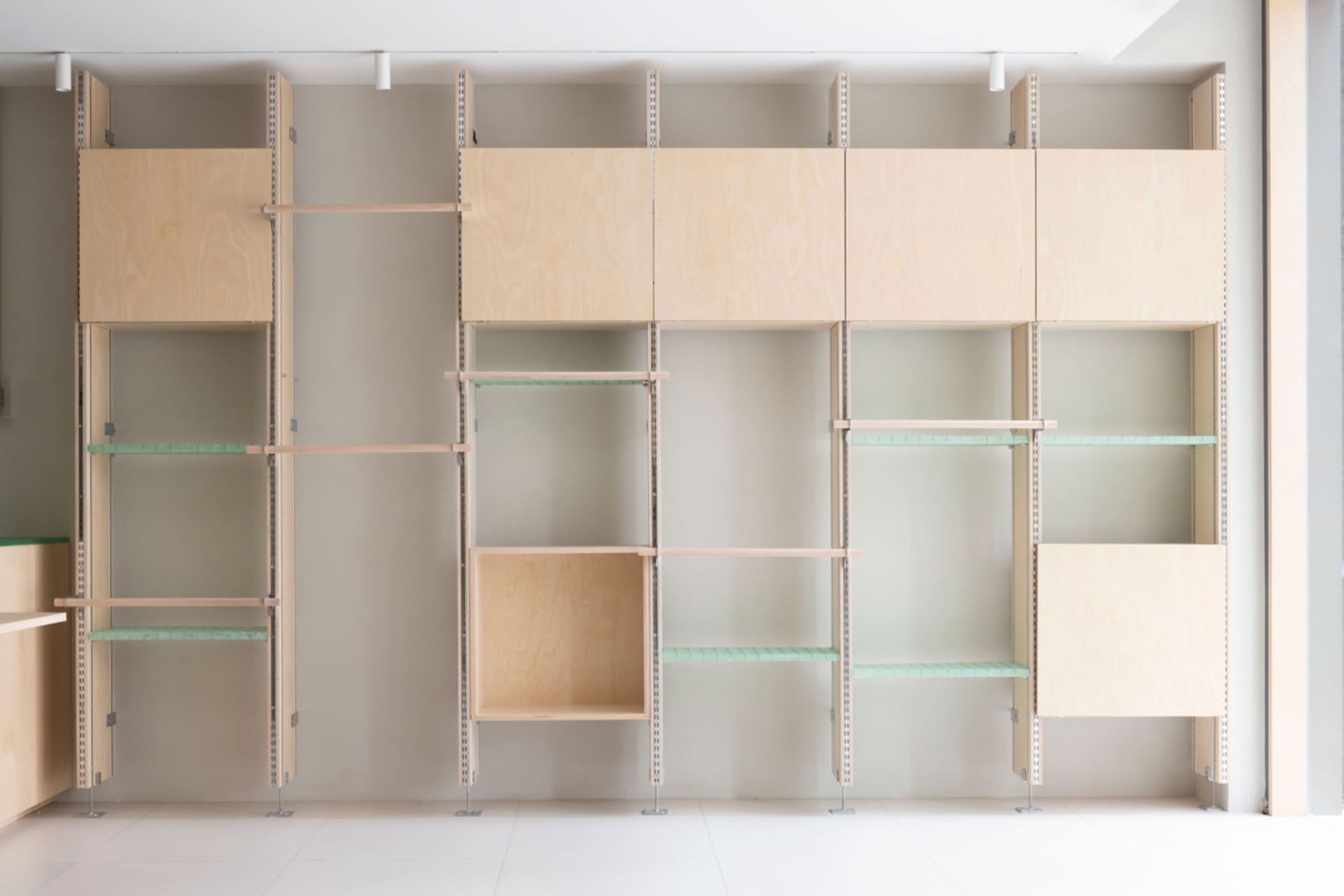 Modern interior design featuring wooden shelves against a white wall.