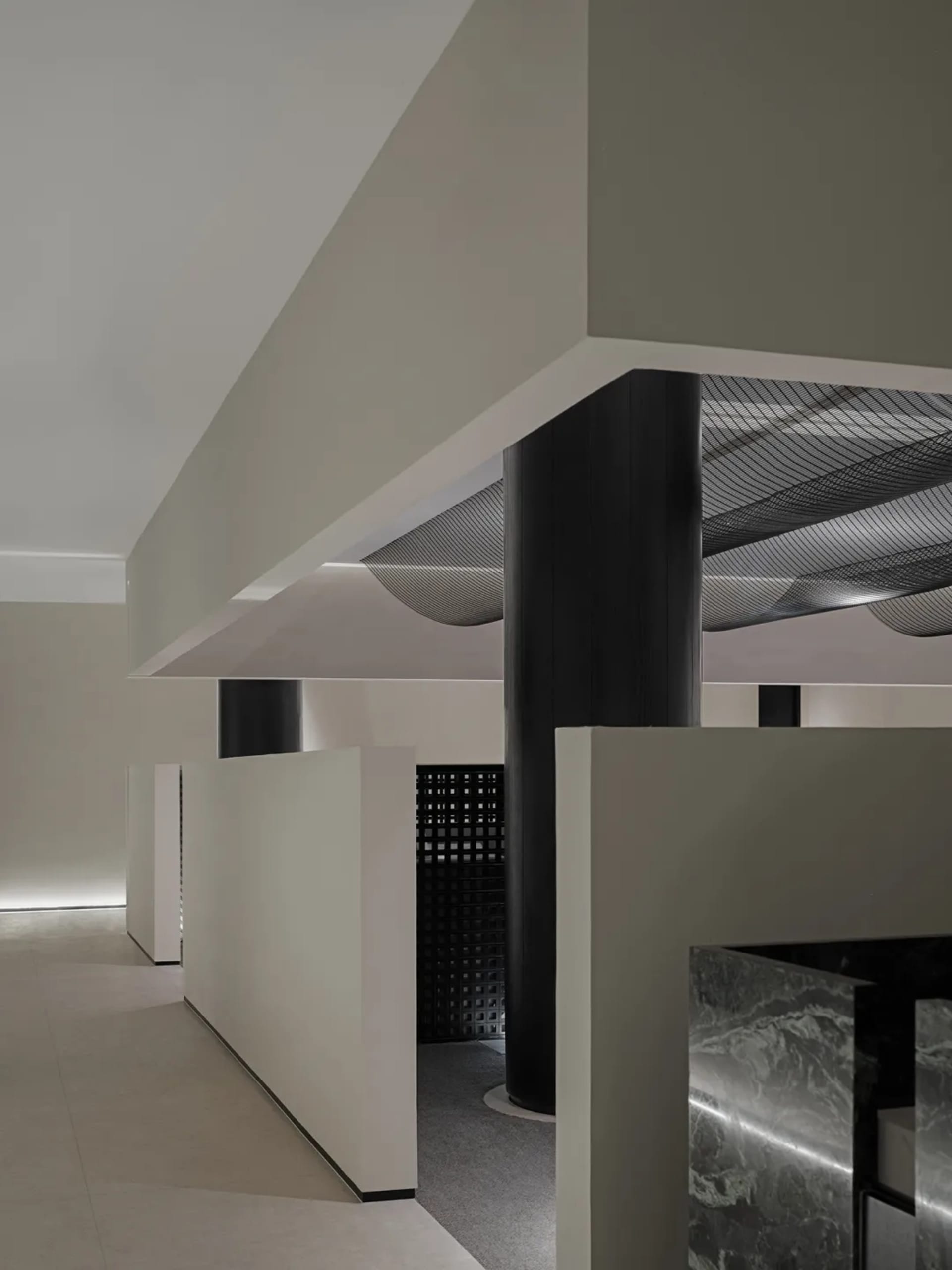 Minimalist interior design featuring concrete columns and floors.