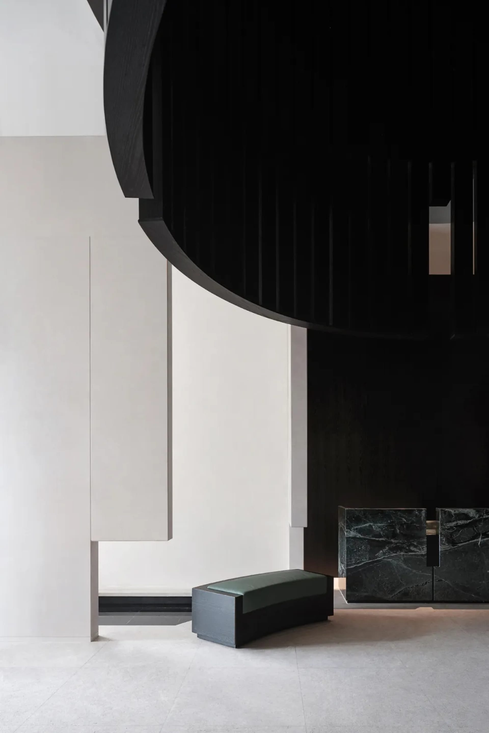 Modern minimalist lobby with concrete walls and marble accents