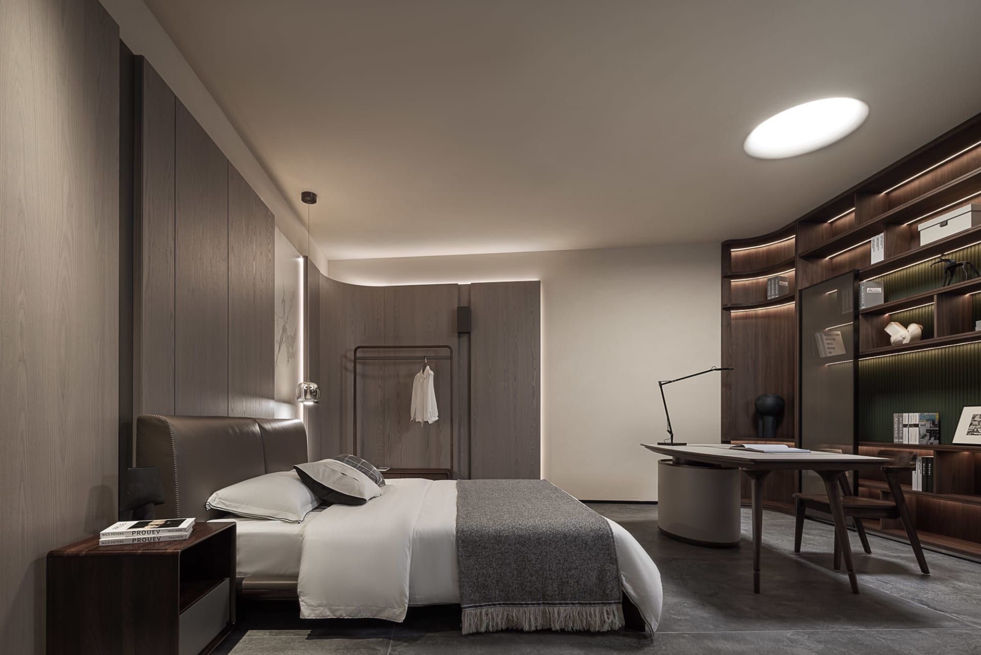 A modern bedroom featuring wooden walls and a bed with white bedding.