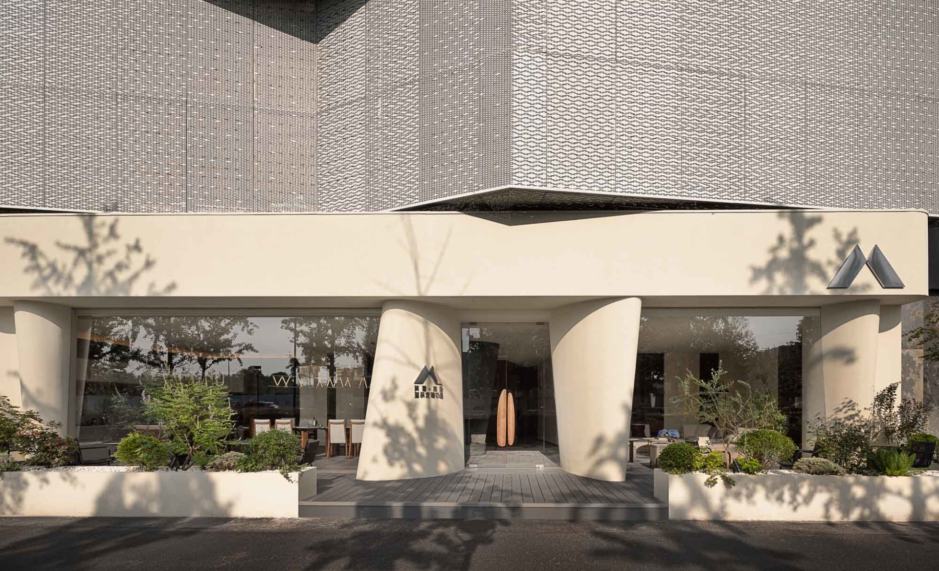 A modern storefront with glass and stone materials.