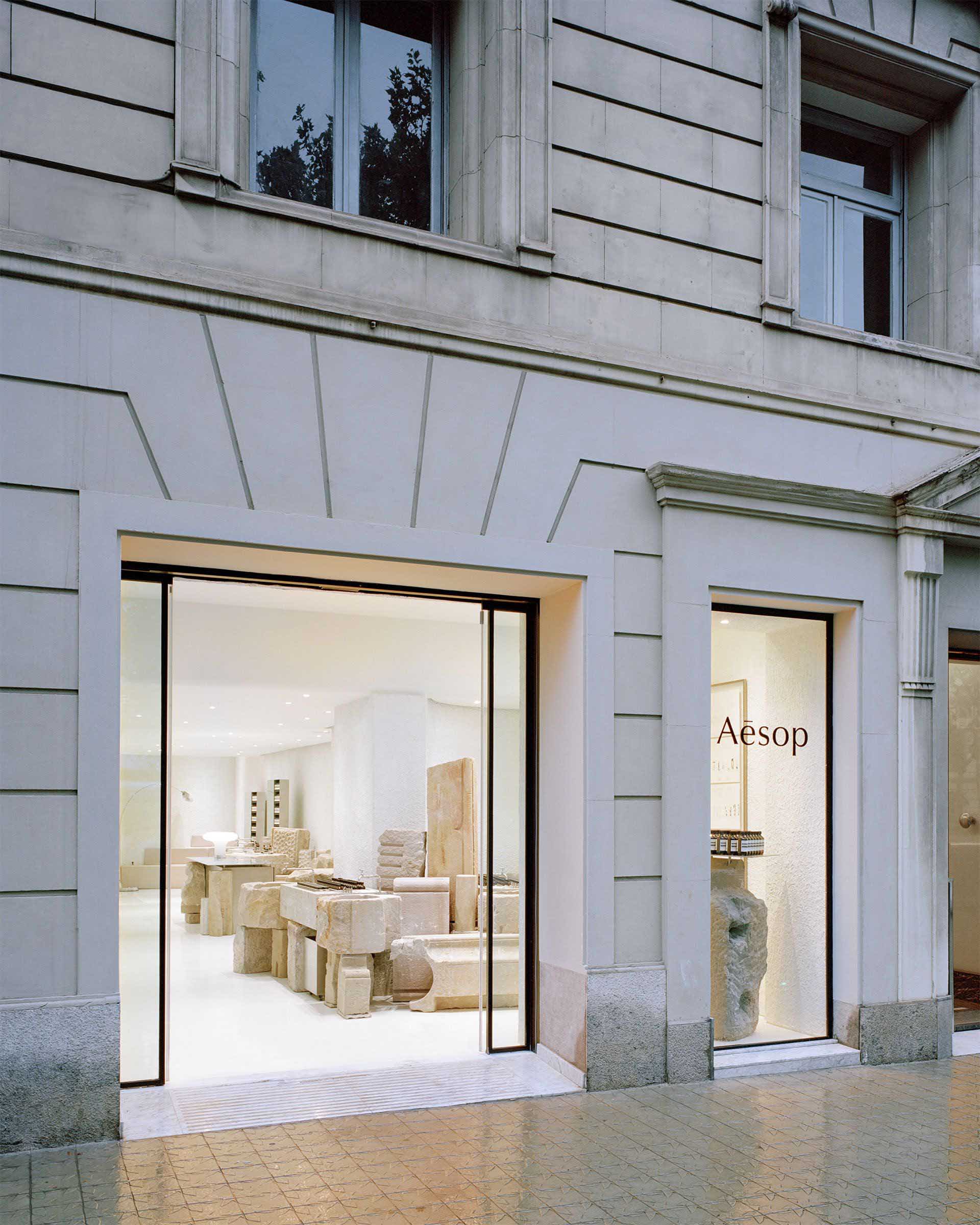 A modern retail storefront with stone elements and a minimalist design.