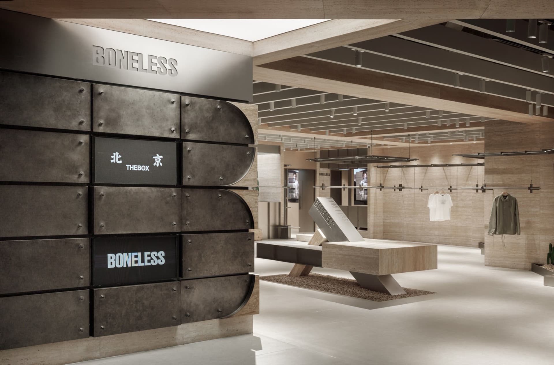 Modern retail space with a metallic wall displaying 'Boneless' text and 'Thebox' and 'Boneless' logos in Chinese and English,