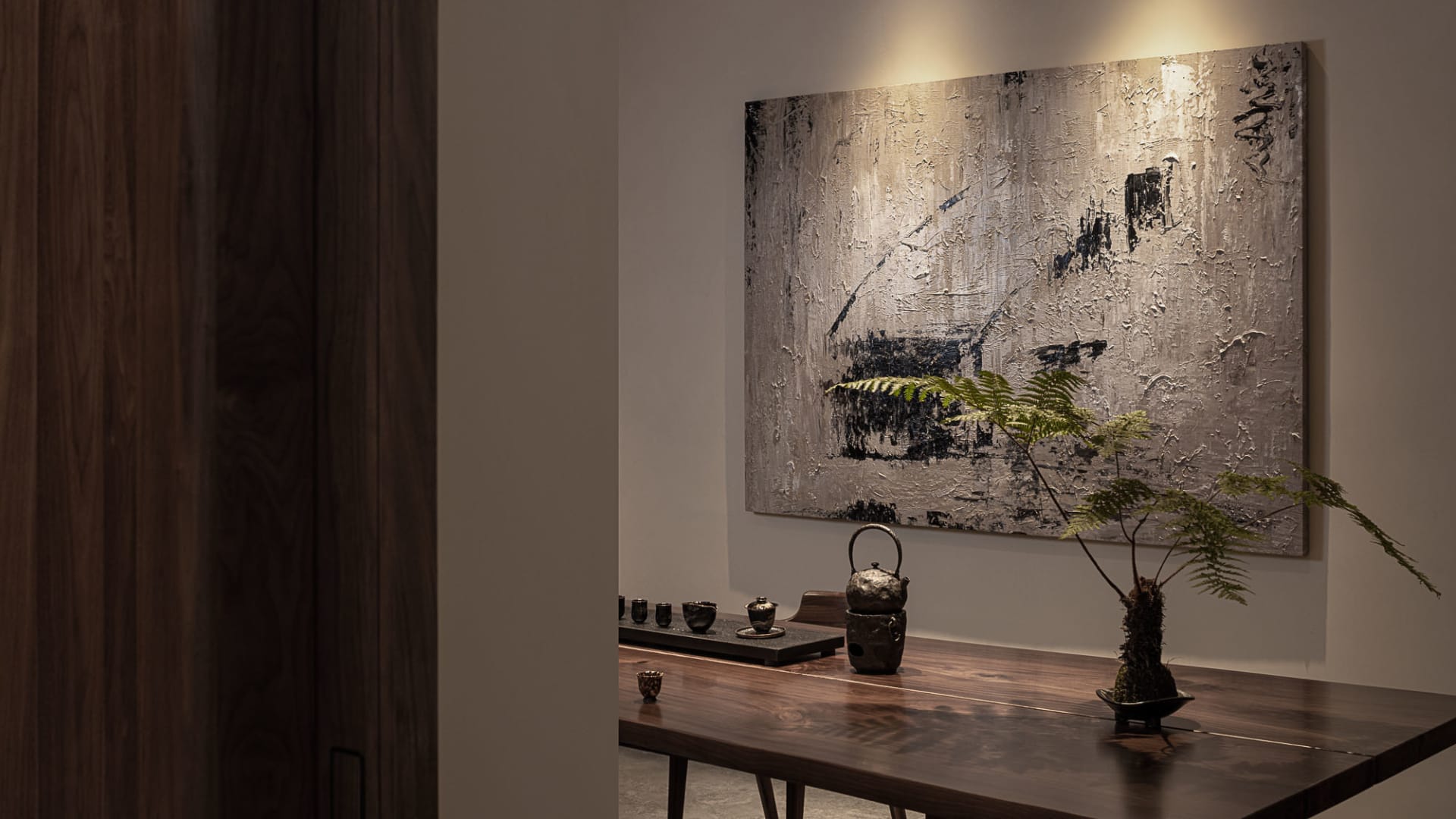 Modern minimalist interior designed in wood with a minimalist artwork on the wall.