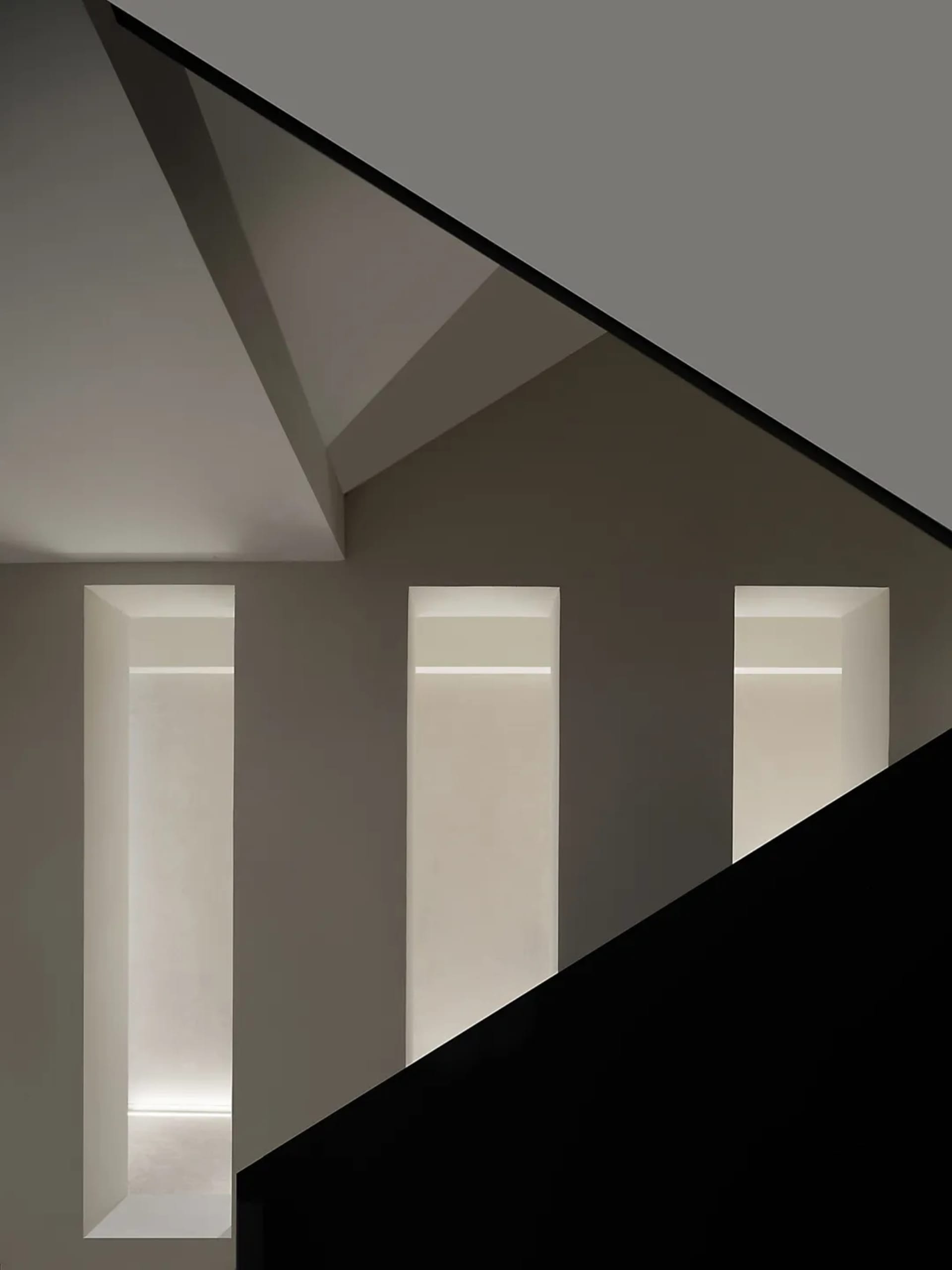 A minimalist design with concrete walls and a black floor.