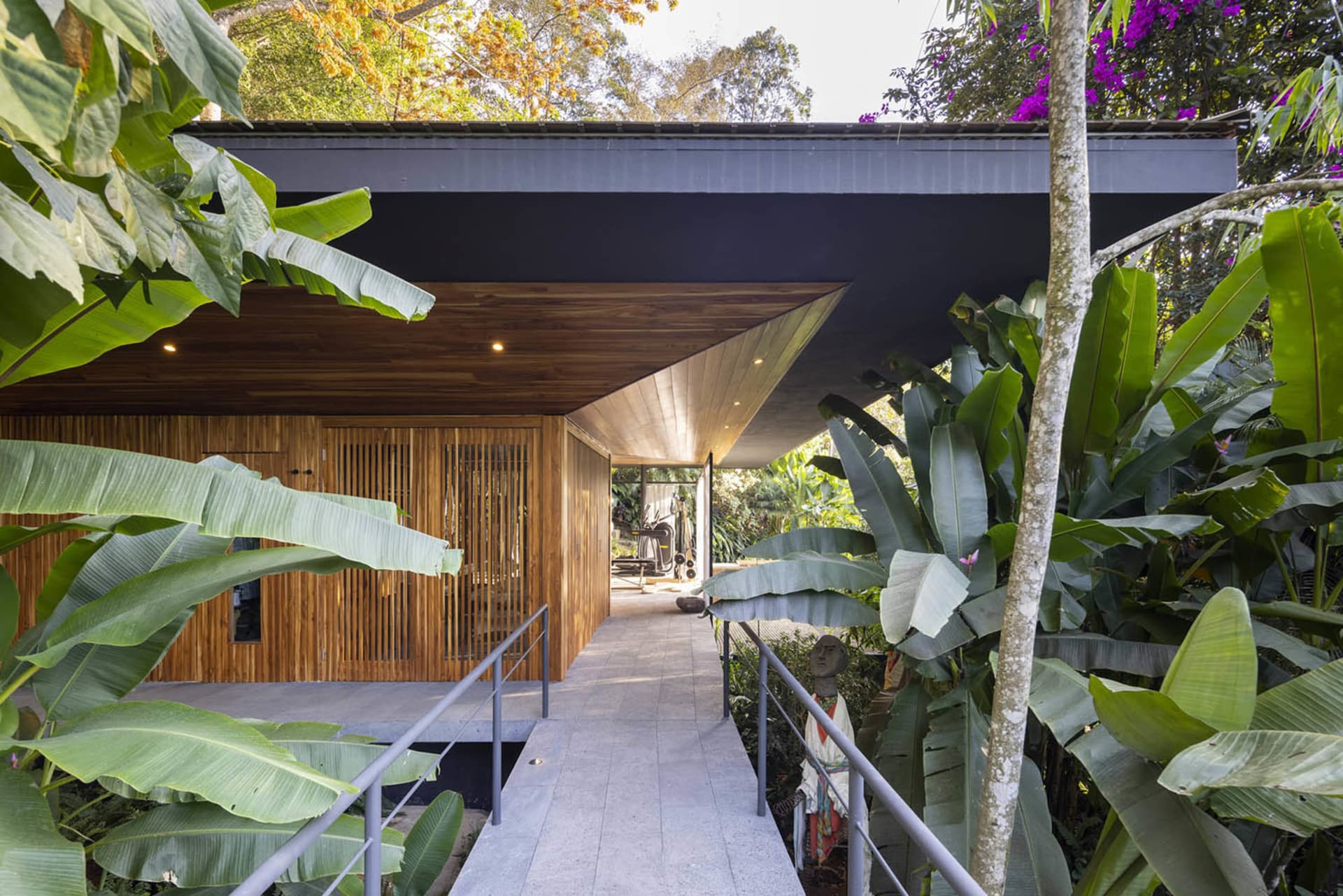 Modern minimalist residential exterior with wood and concrete materials.