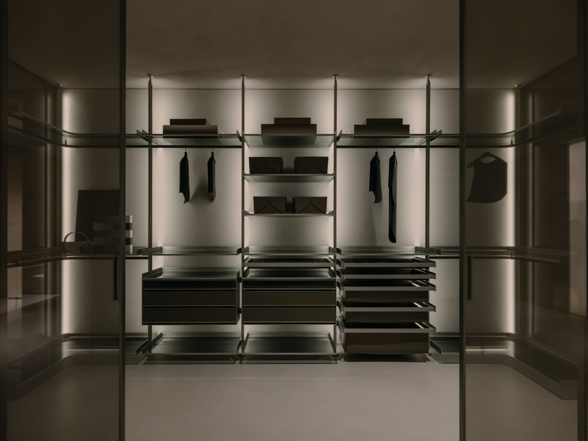 Modern closet with glass doors and steel shelves, featuring sleek design and elegant storage solutions.