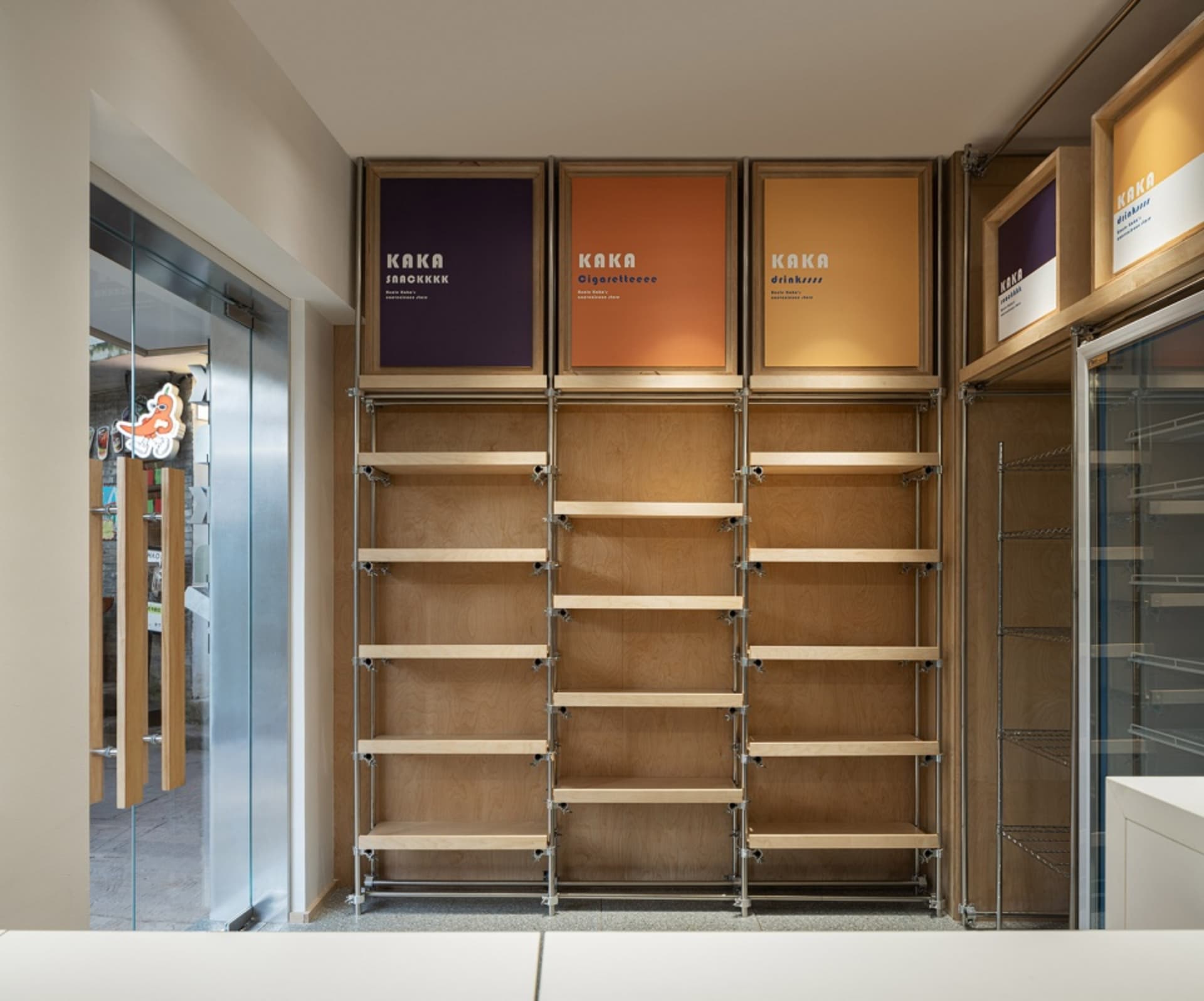 Modern retail shop interior with wooden shelves and branding graphics.