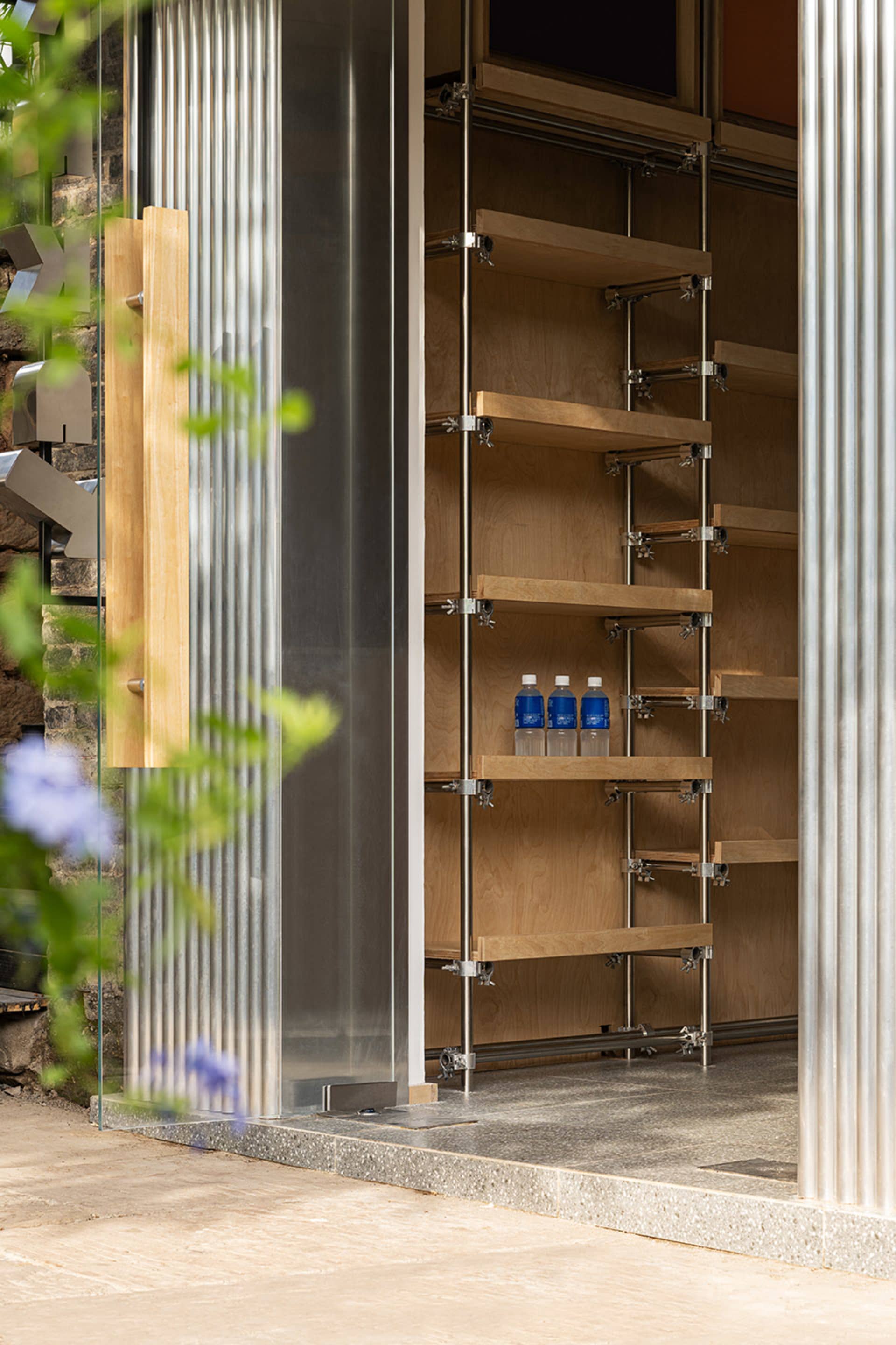 A modern shop with a metal frame and glass walls.
