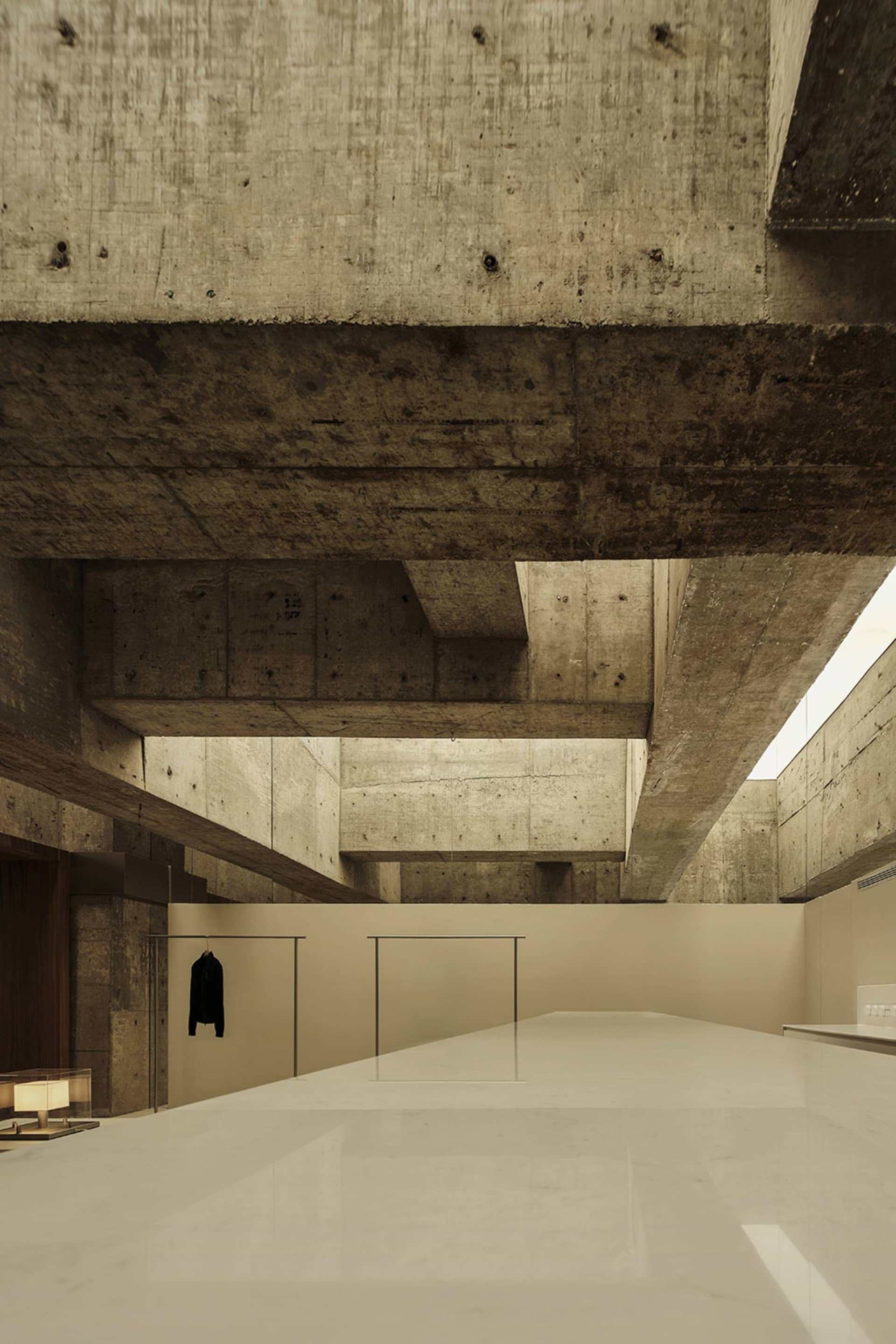 Modern minimalist interior featuring concrete and marble materials.