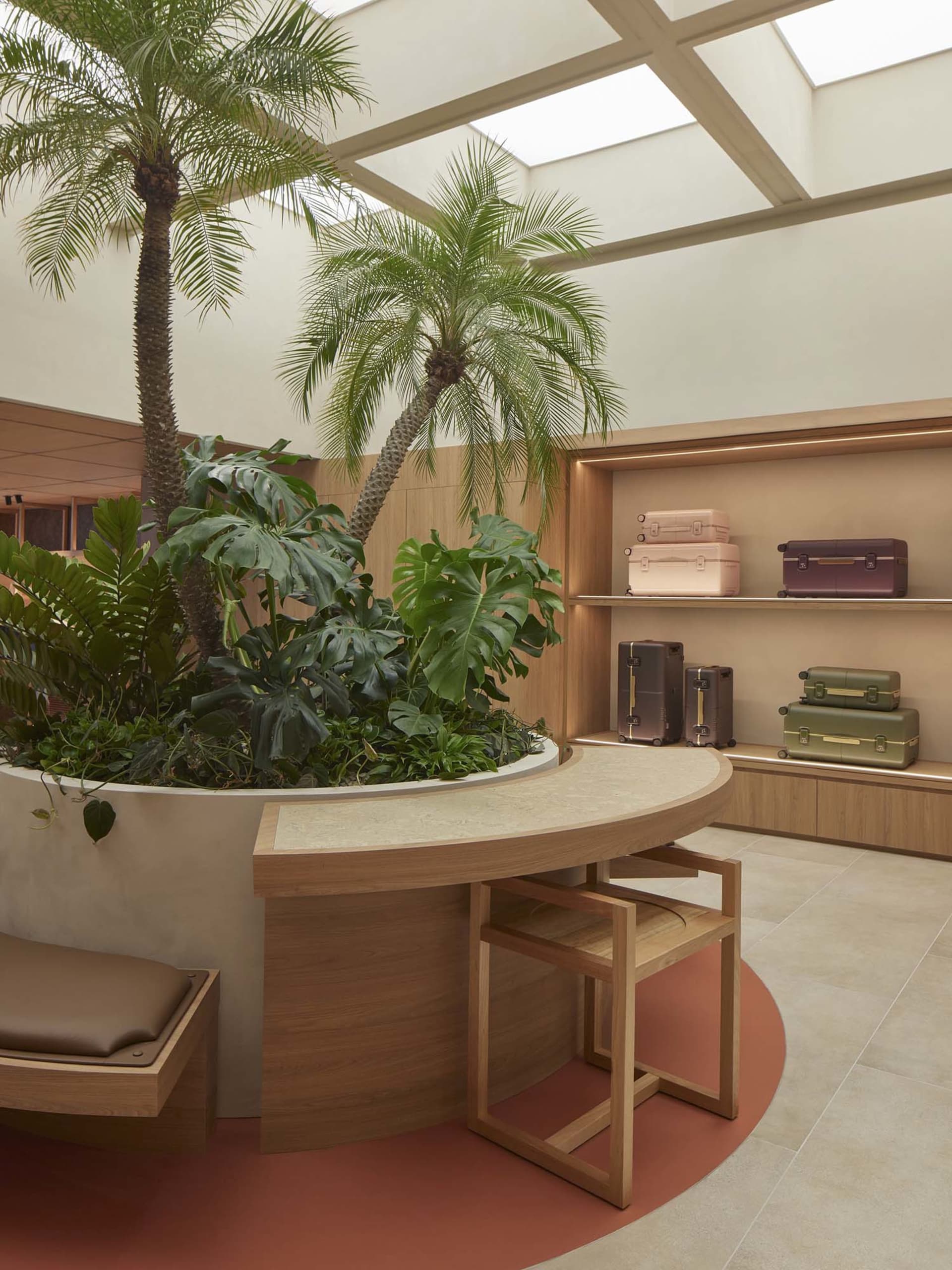 A modern retail shop featuring industrial design elements with concrete floors, wooden furniture, and glass displays.