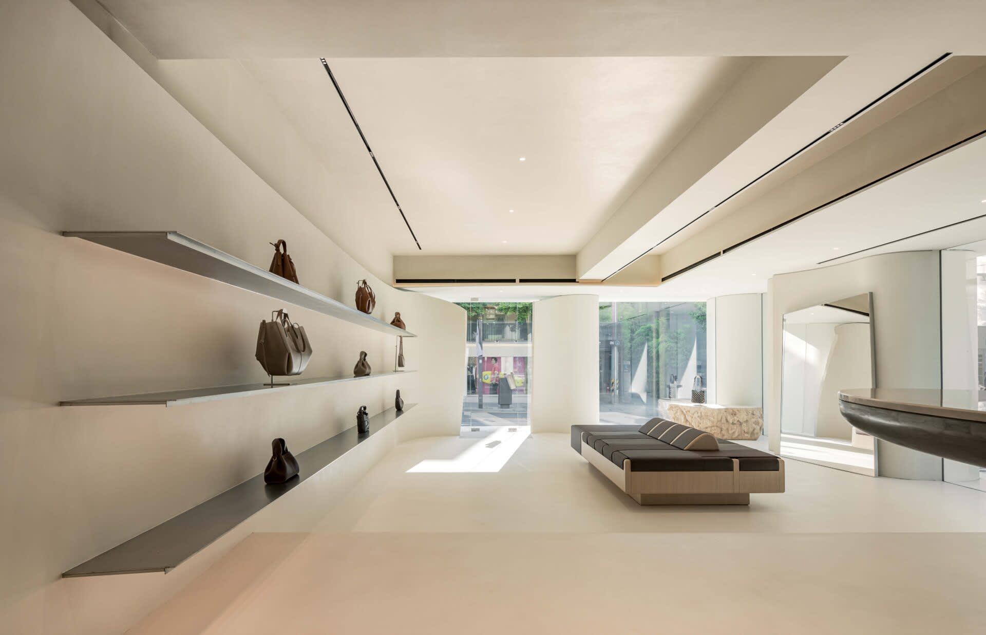 A minimalist retail storefront with concrete walls and a sleek, modern design.
