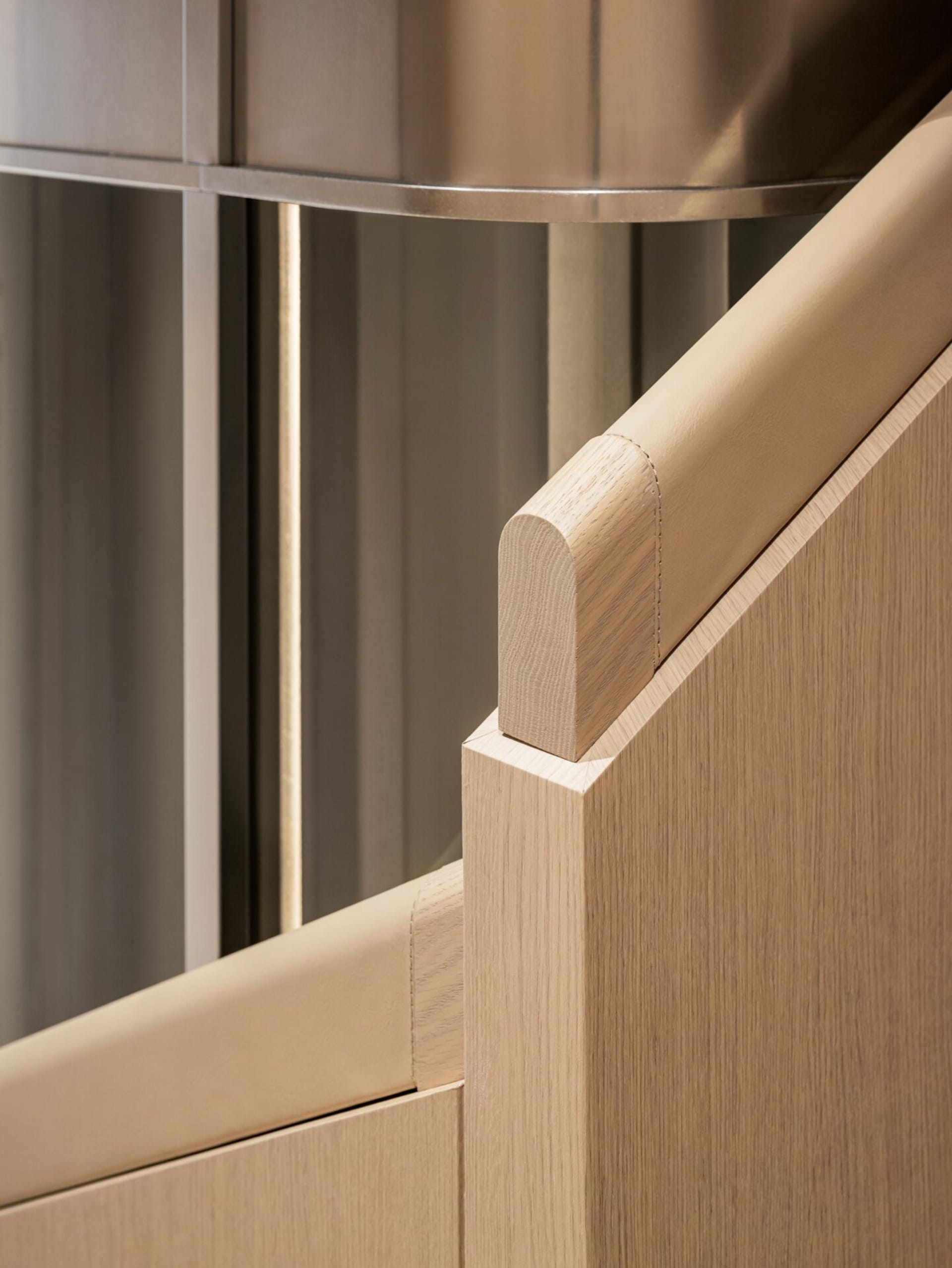 Modern stairs with a wooden handrail and base, featuring clean lines and a minimalist design.