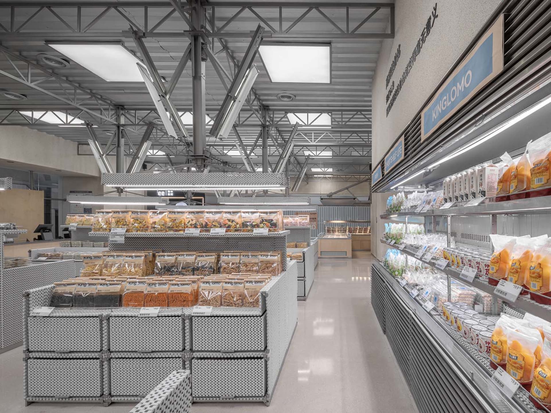 A modern industrial supermarket with metal shelving units displaying various food items.