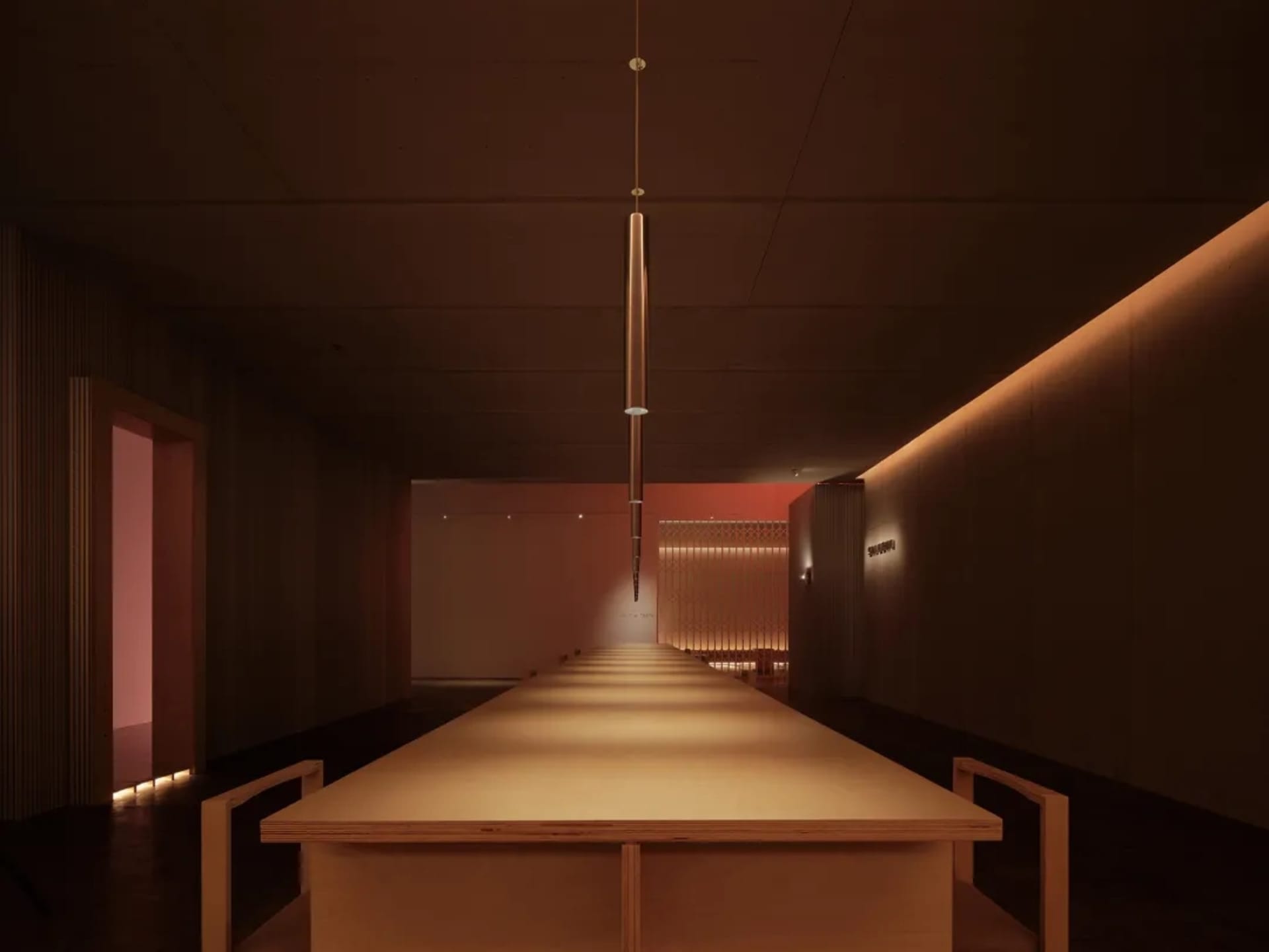 A minimalist restaurant interior with a long wooden table and modern lighting fixtures.