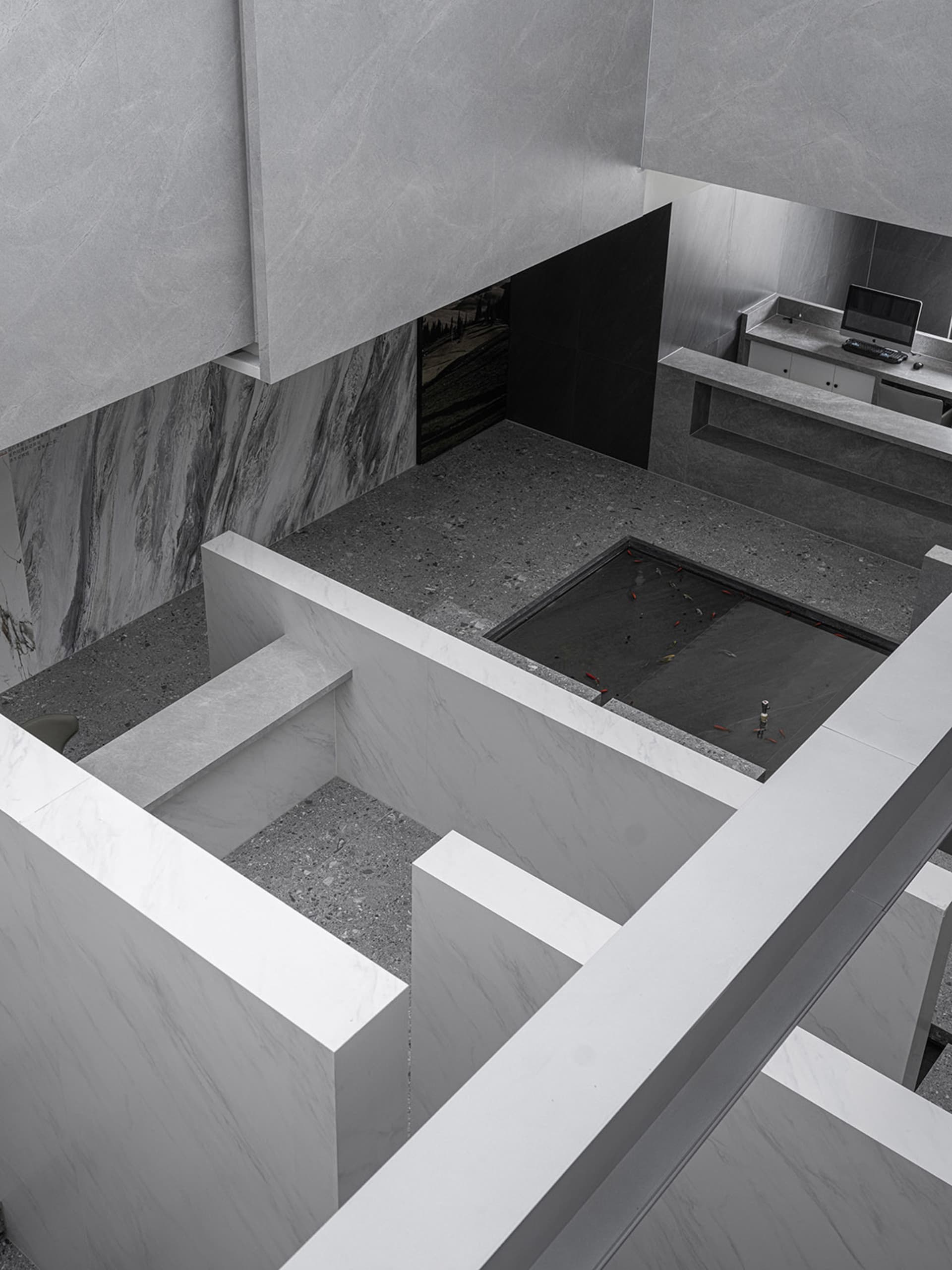 Modern, minimalist kitchen with marble countertops and floors.