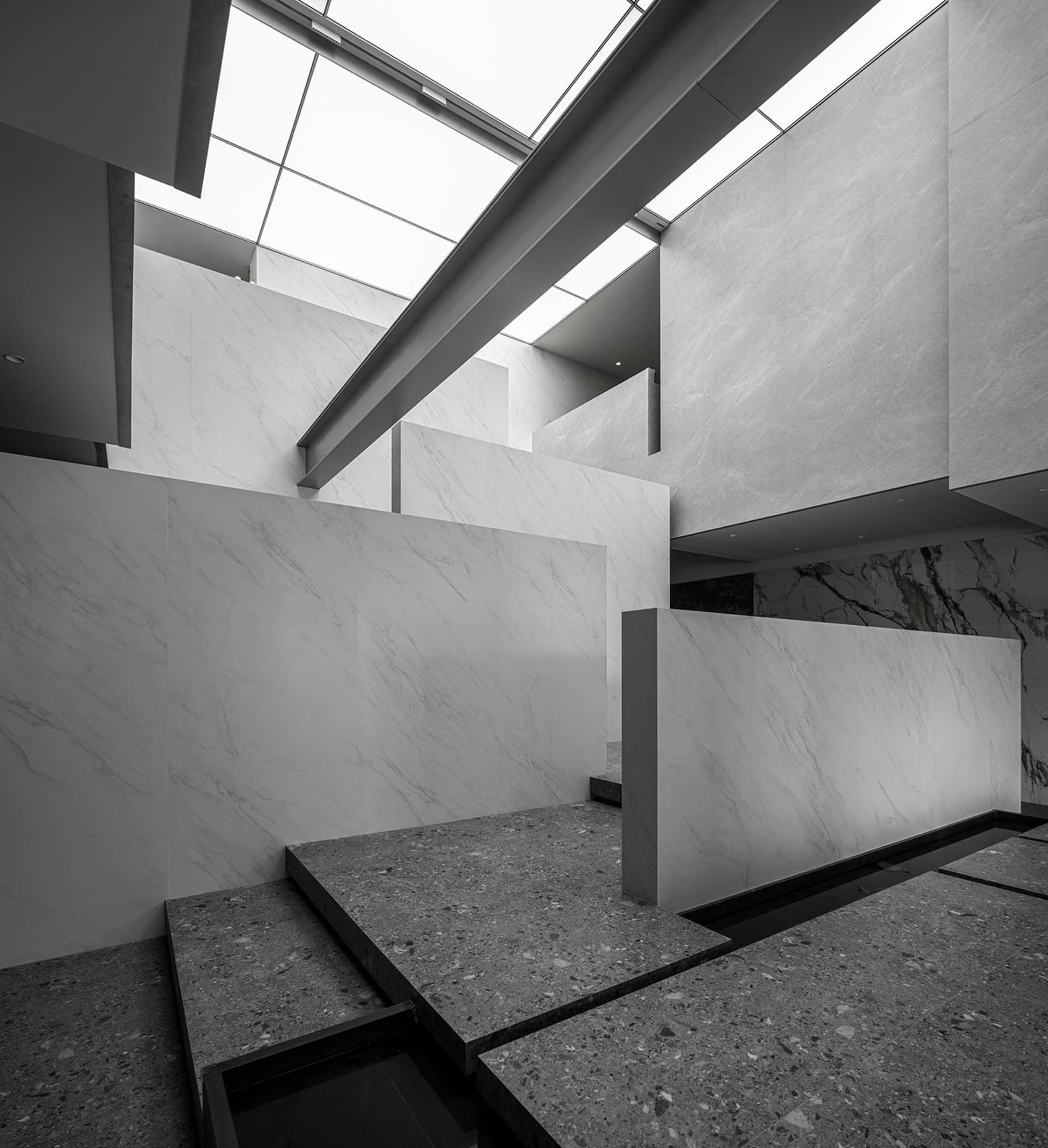 An interior space featuring white marble and concrete elements