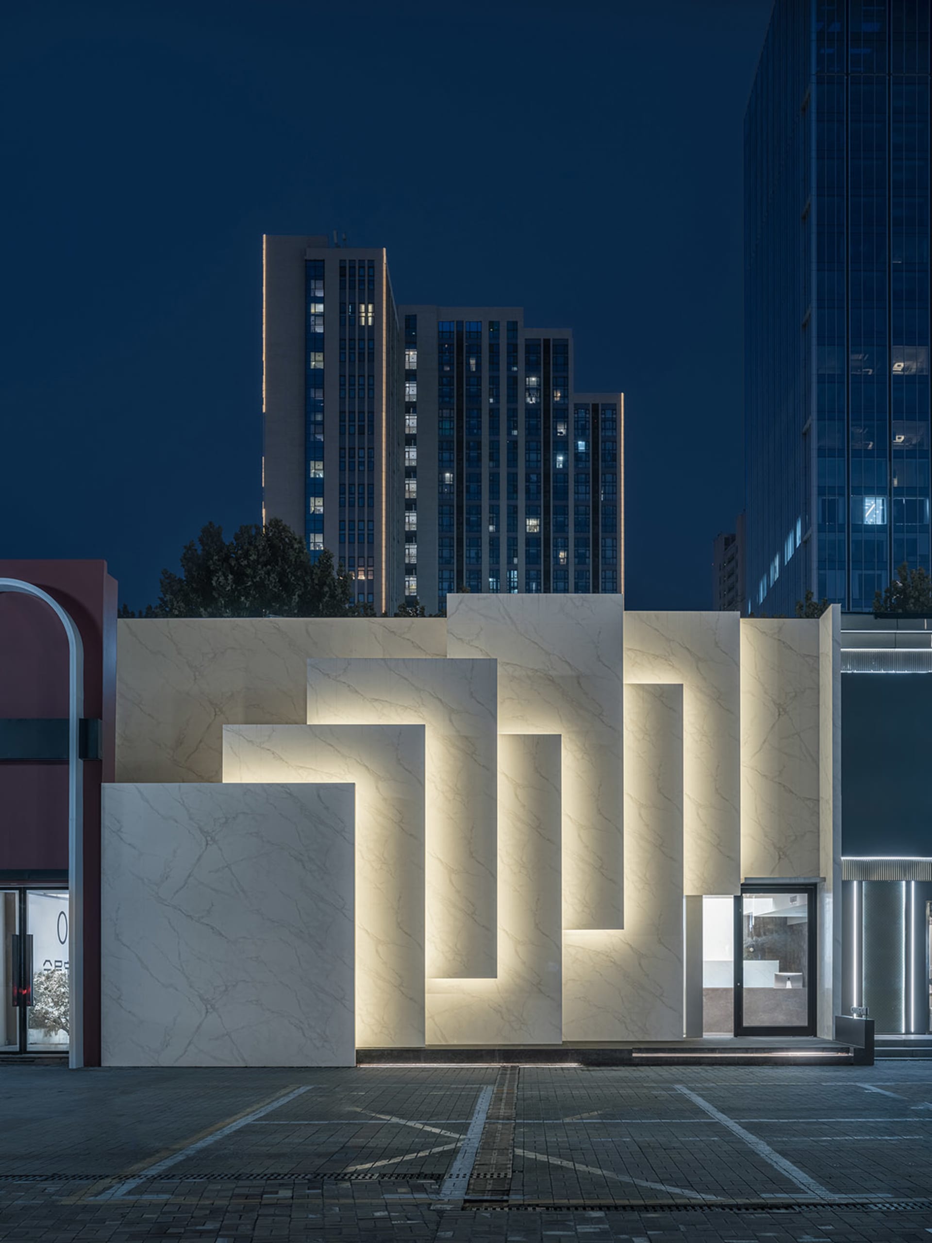 A modern storefront with illuminated marble panels and a sleek design.
