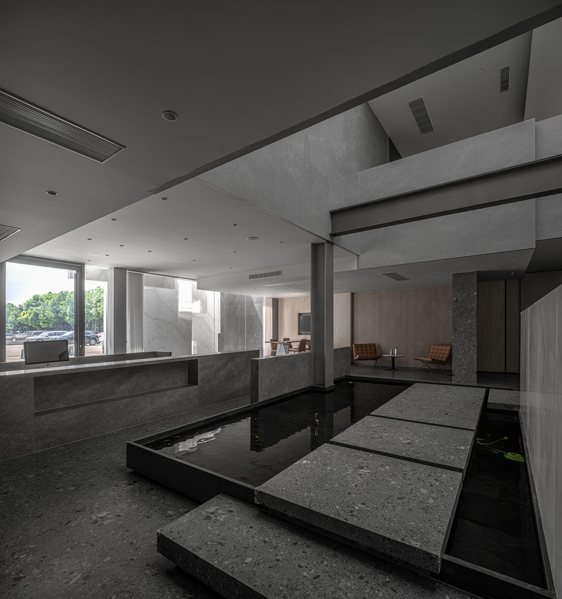 A modern office space featuring concrete and glass materials.