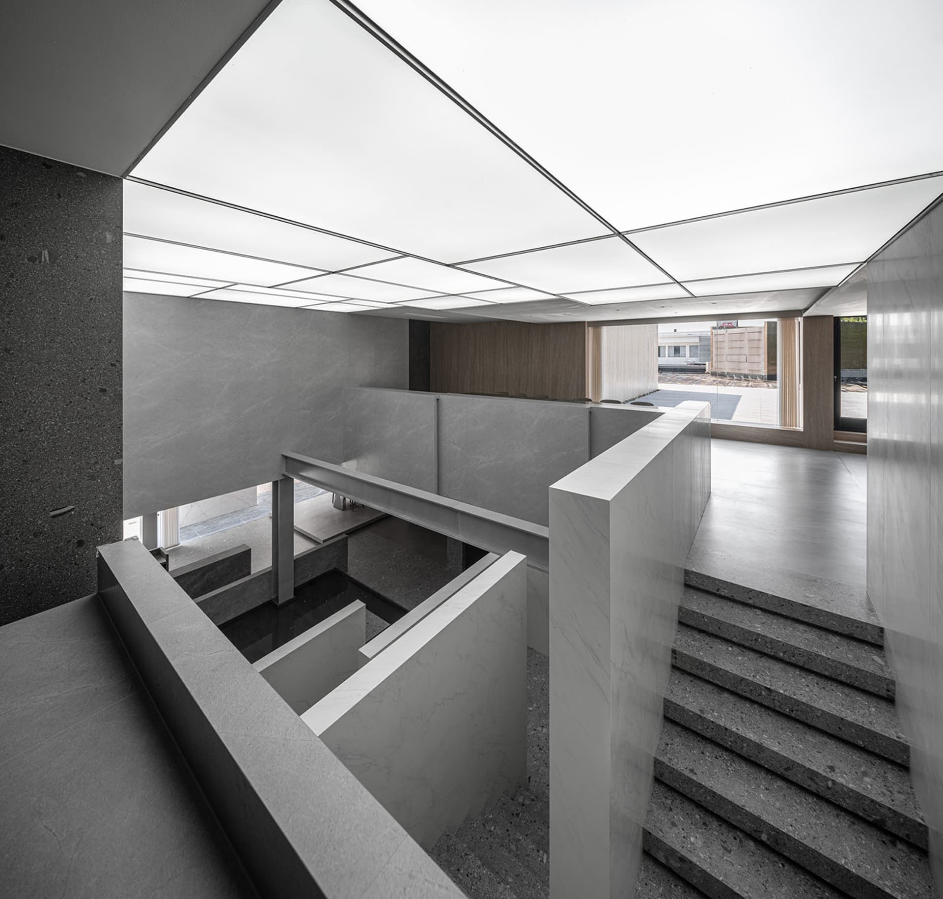 A modern office space featuring a combination of concrete and marble materials.