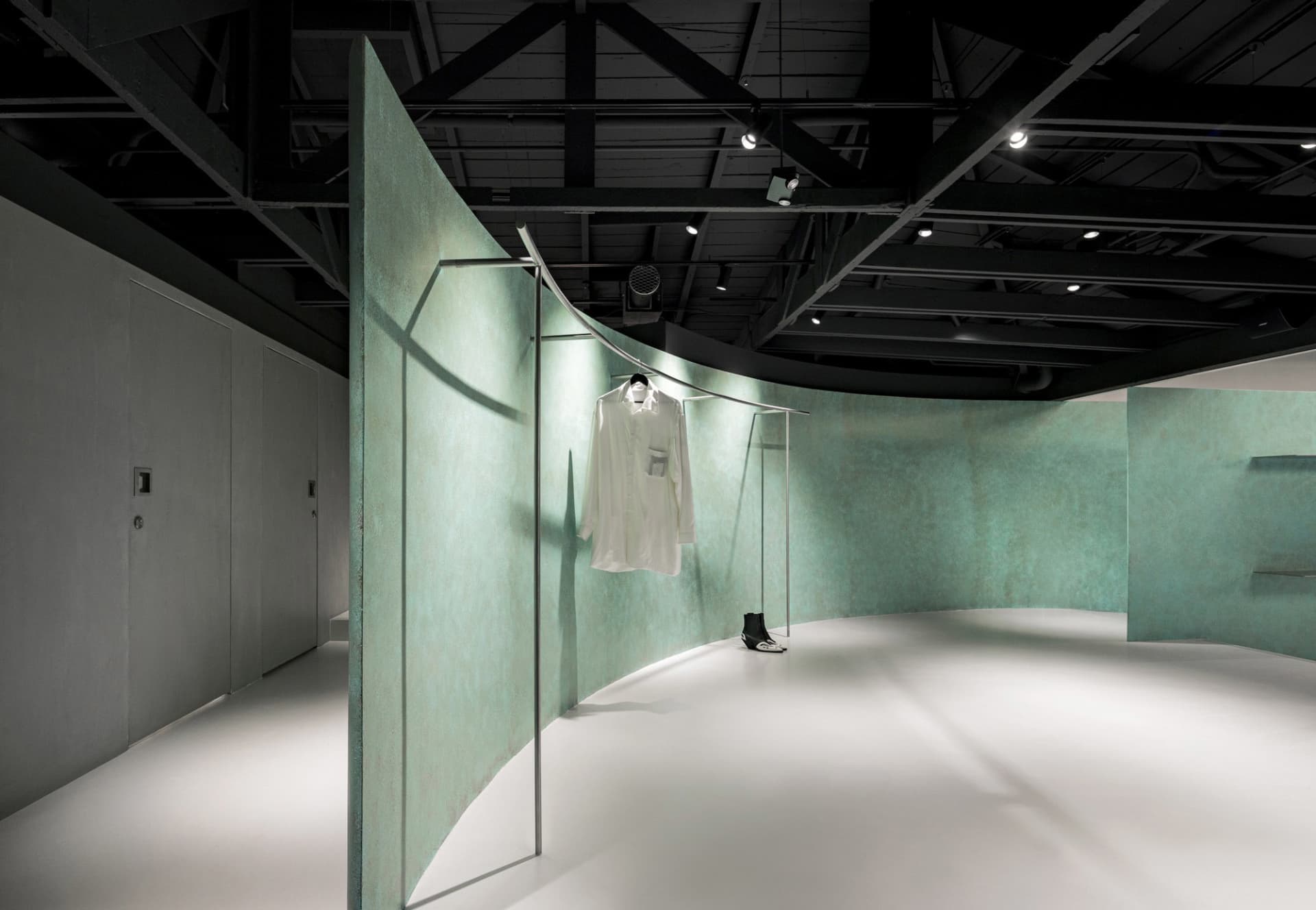 Modern retail space featuring exposed concrete walls and minimalist design.