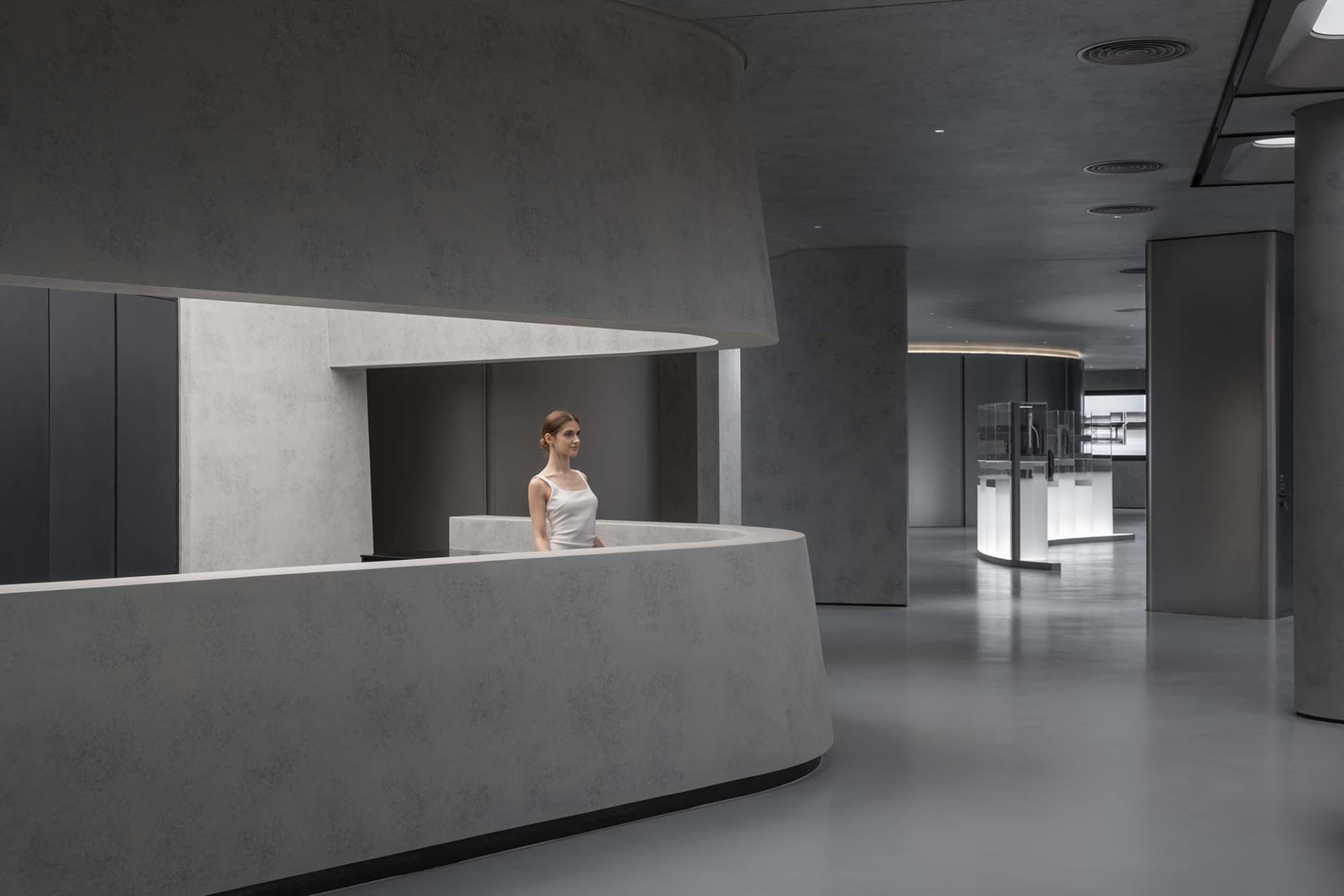 Modern minimalist office space with concrete finishes and sleek design.