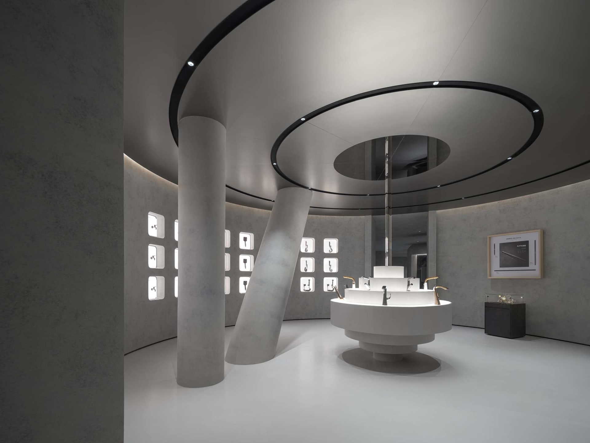 A minimalist showroom featuring concrete, glass, and steel materials.