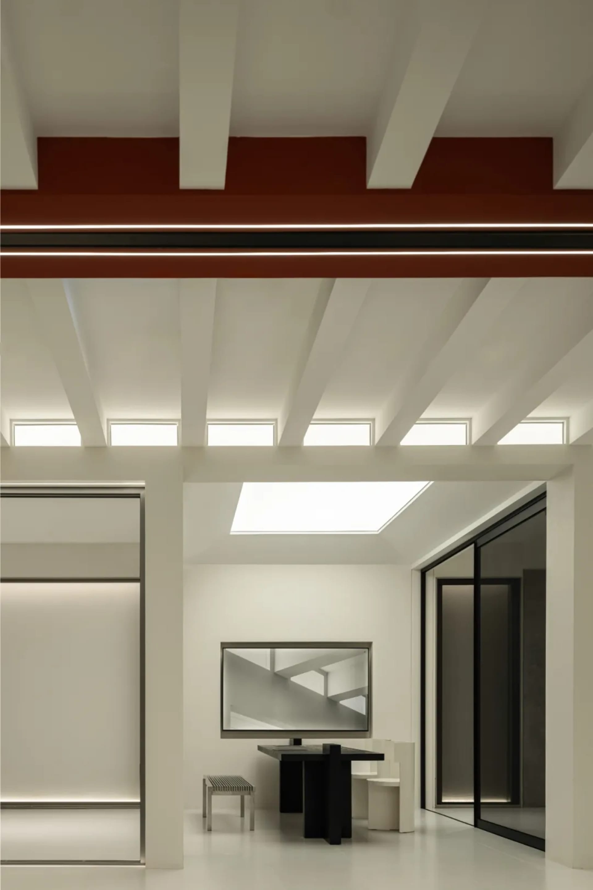 Contemporary interior space with exposed metal beams and a skylight