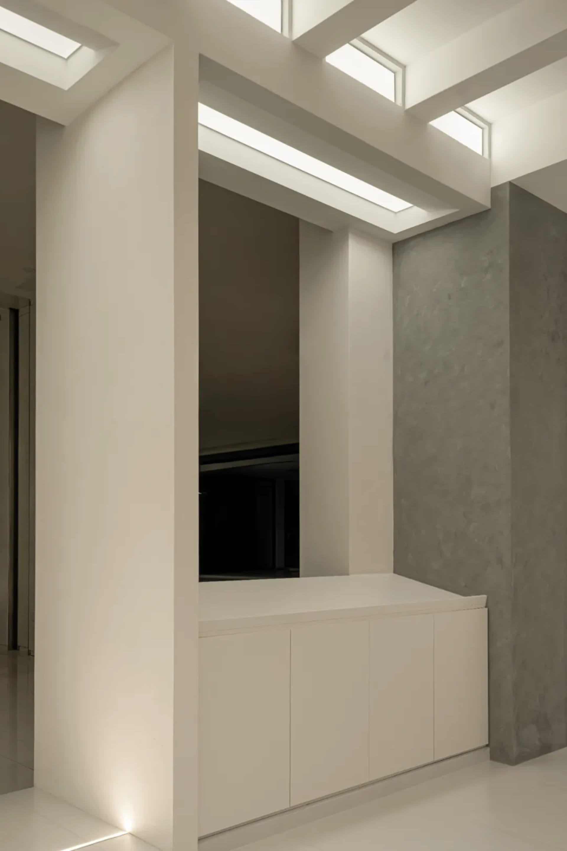 Modern lounge area with concrete walls and floor, featuring a minimalist and industrial design aesthetic.
