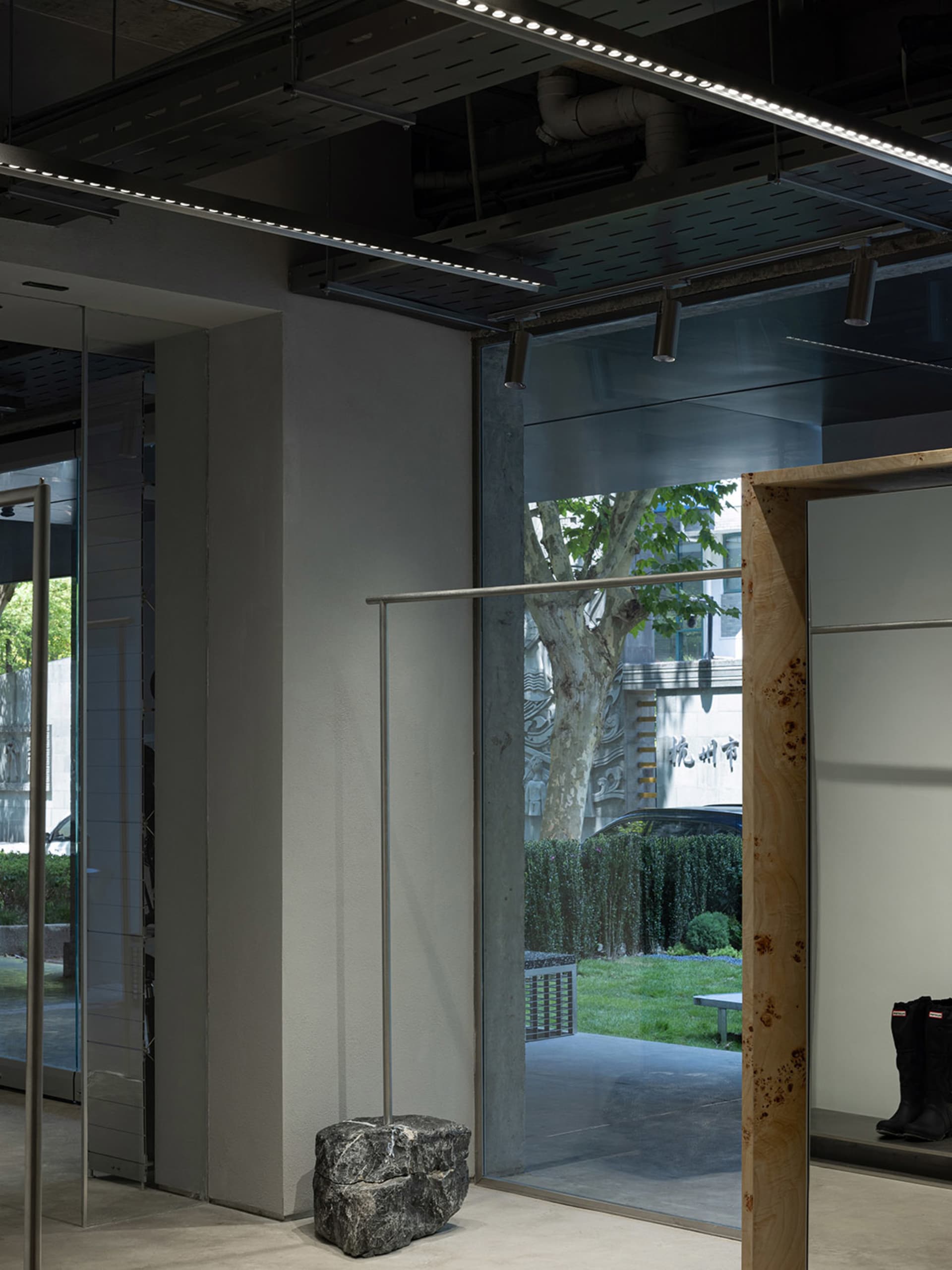 A modern storefront with glass walls and a concrete structure.