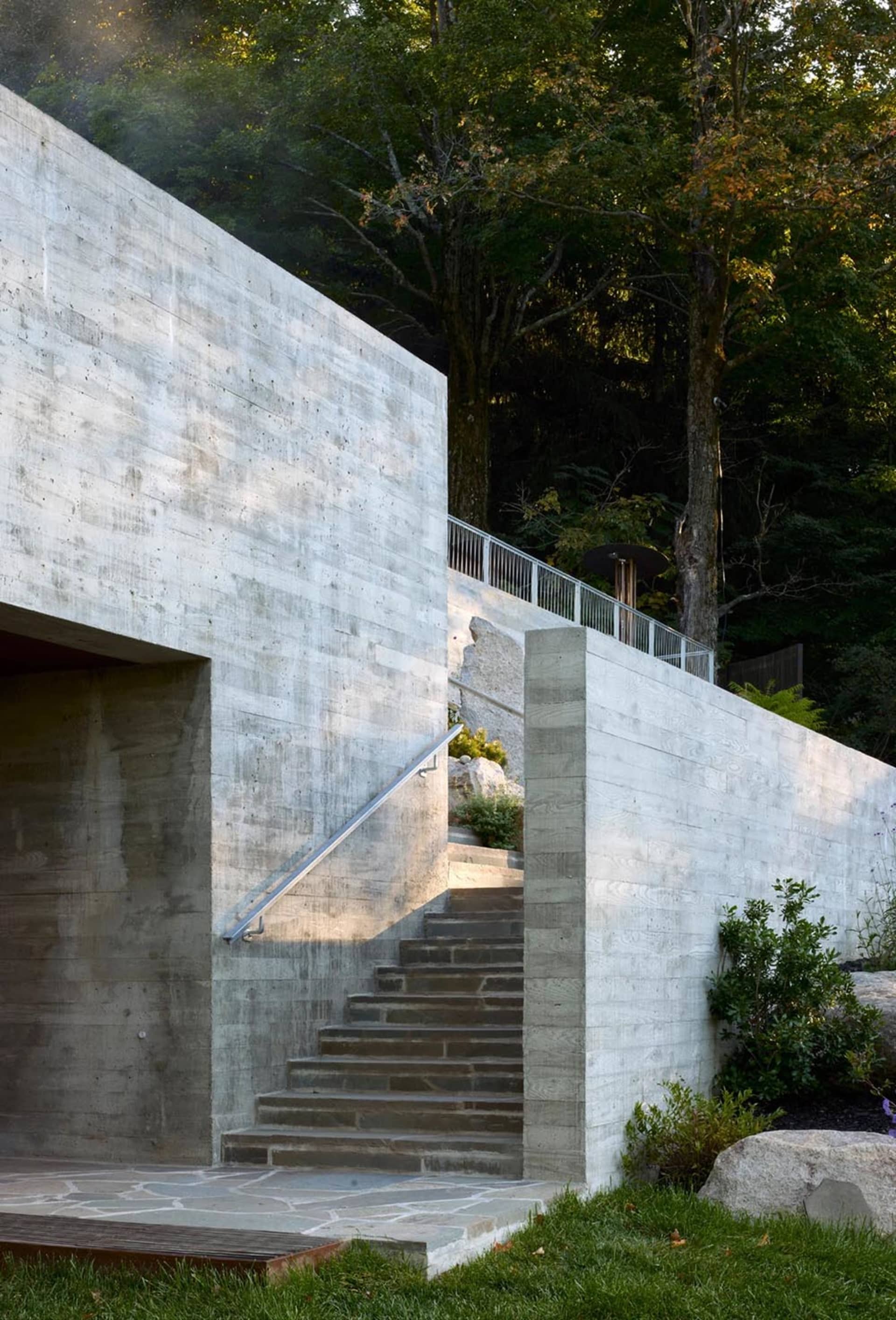 Concrete stairs leading up to a modern building exterior with a minimalist design.