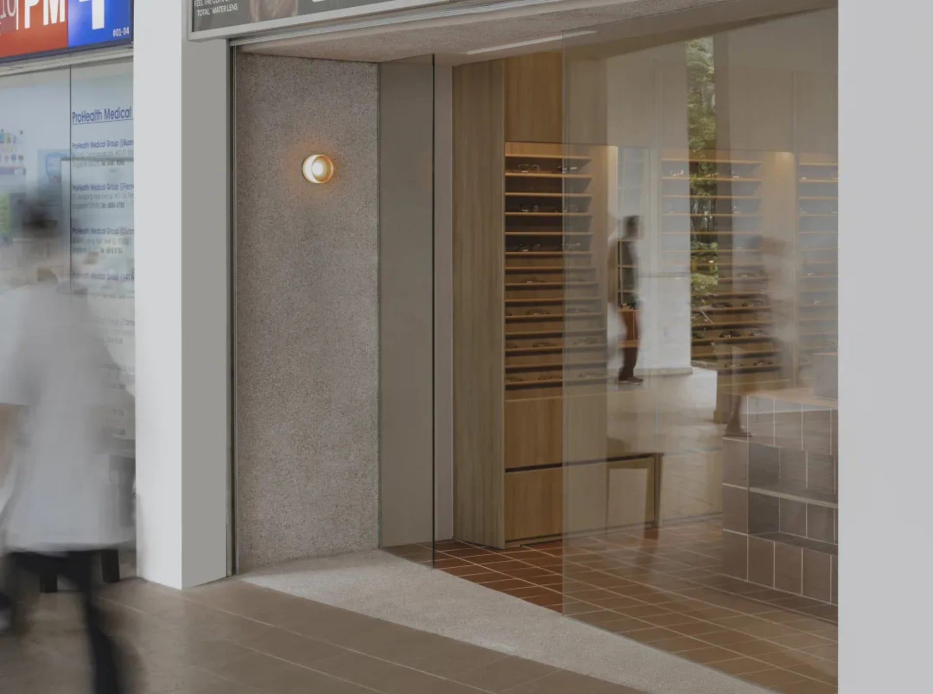 Modern retail storefront with glass windows and interior shelving.