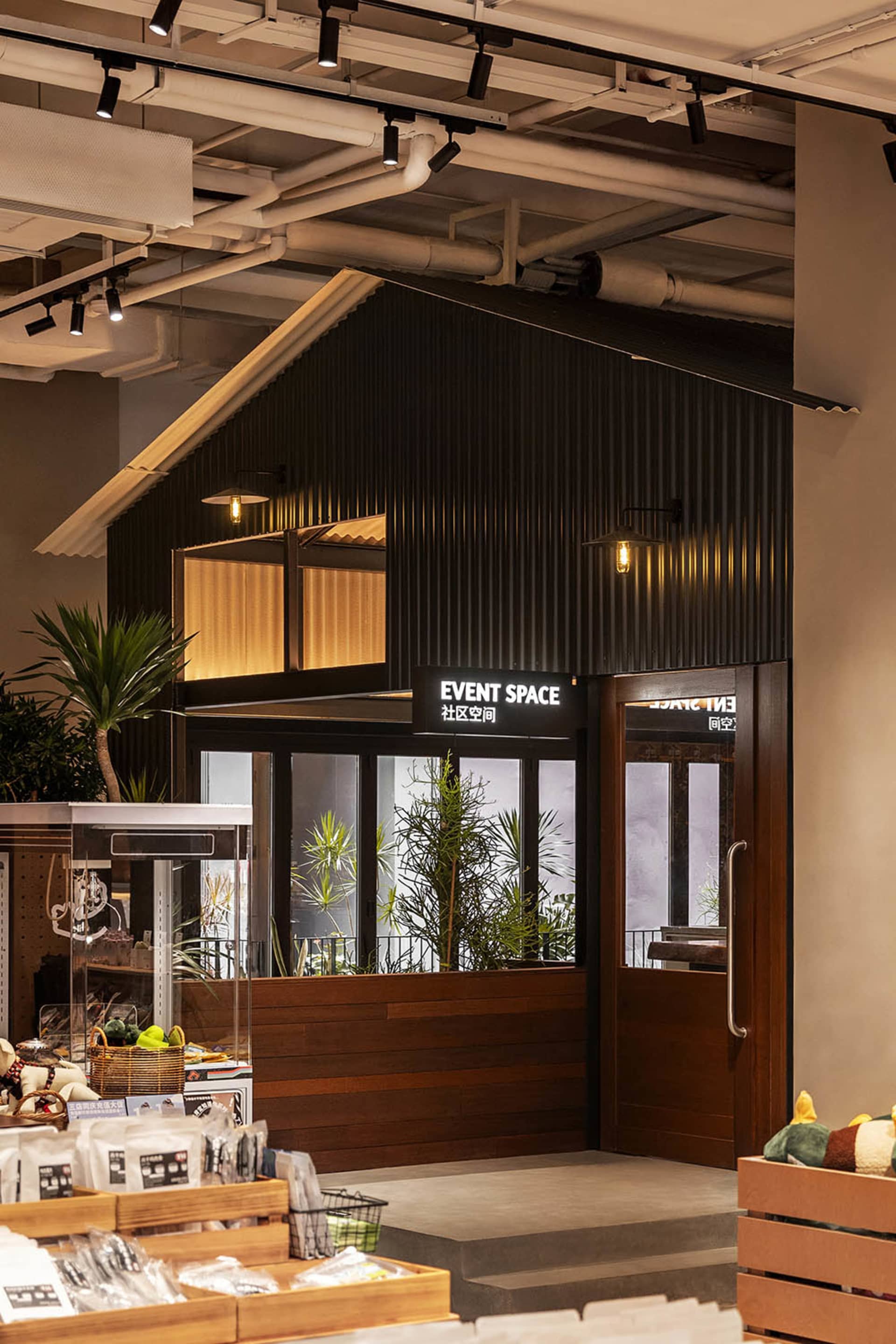 A modern event space entry with corrugated metal cladding and glass windows.