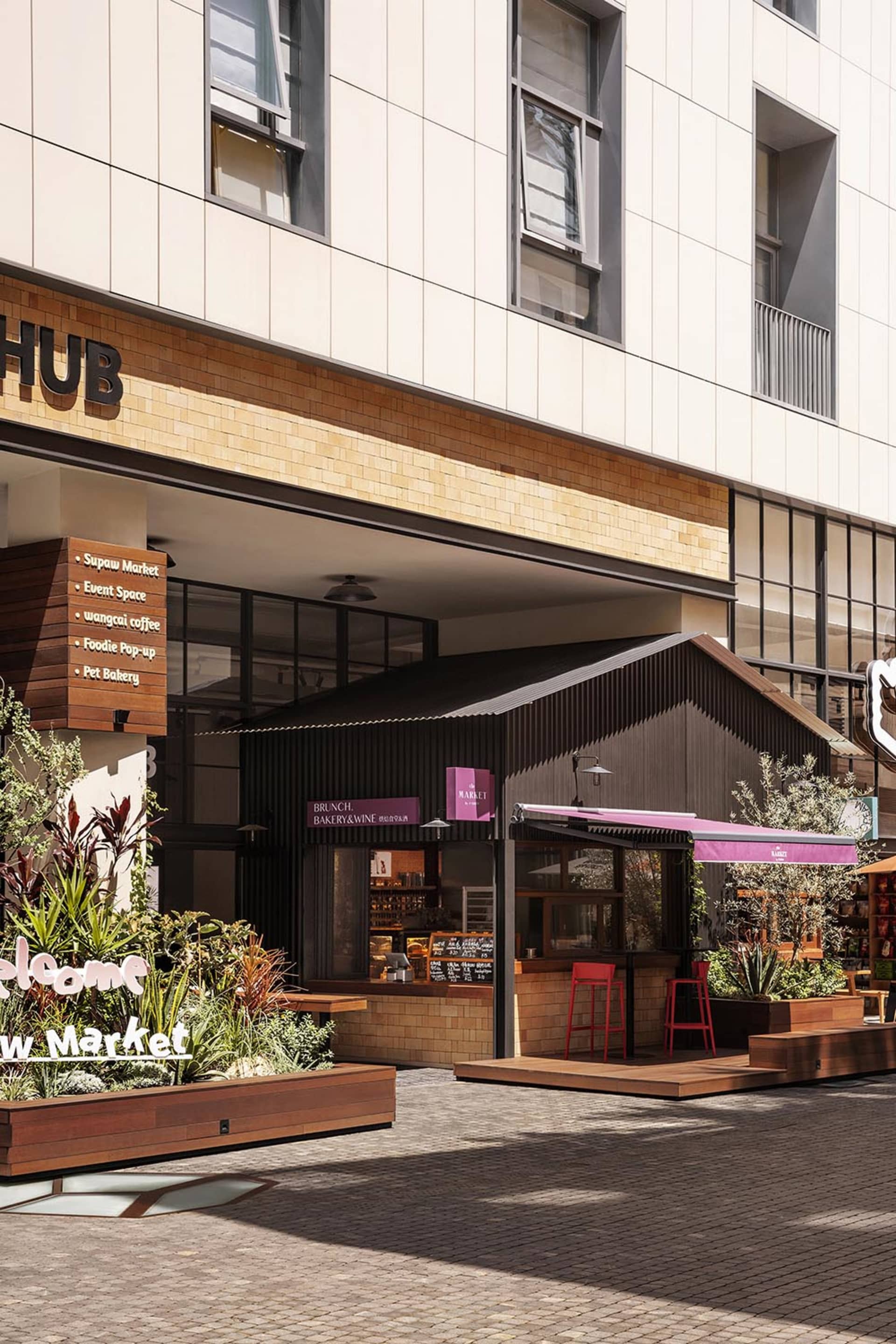 An urban retail storefront featuring wooden awnings, brick walls, and metal accents.