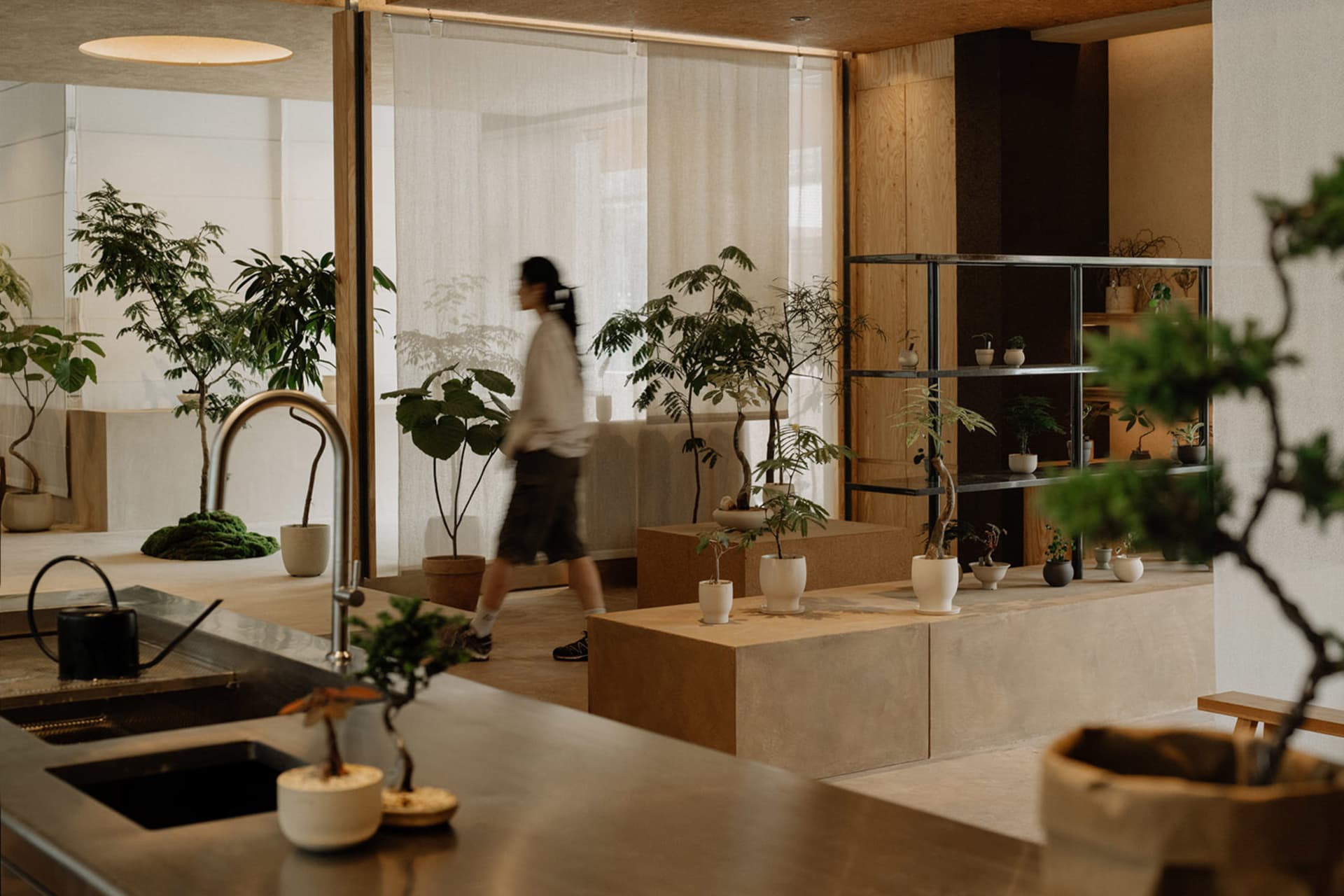 A modern office space with minimalist design featuring concrete and wooden elements.