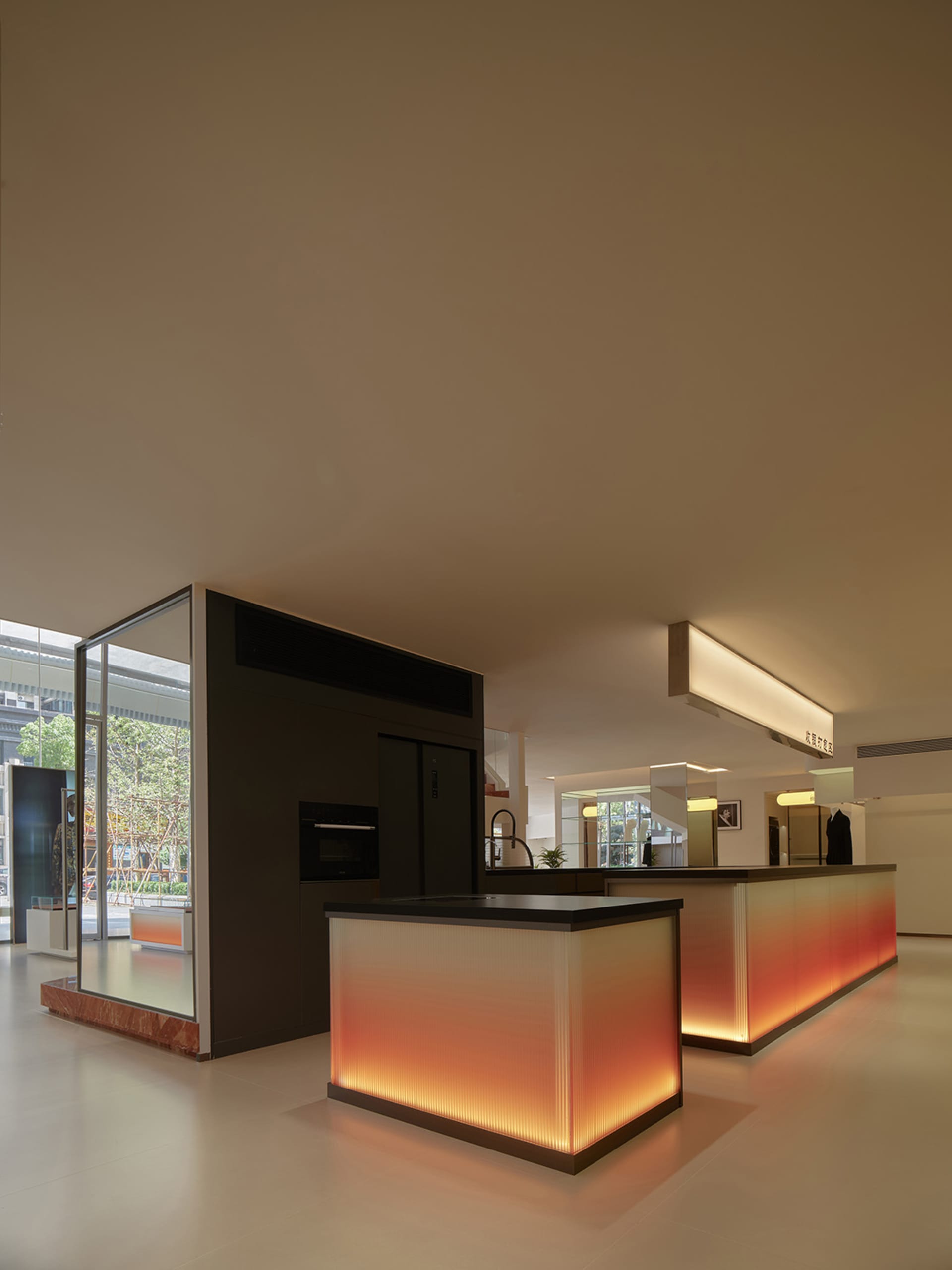 A modern retail space with illuminated glass walls and a central island counter.