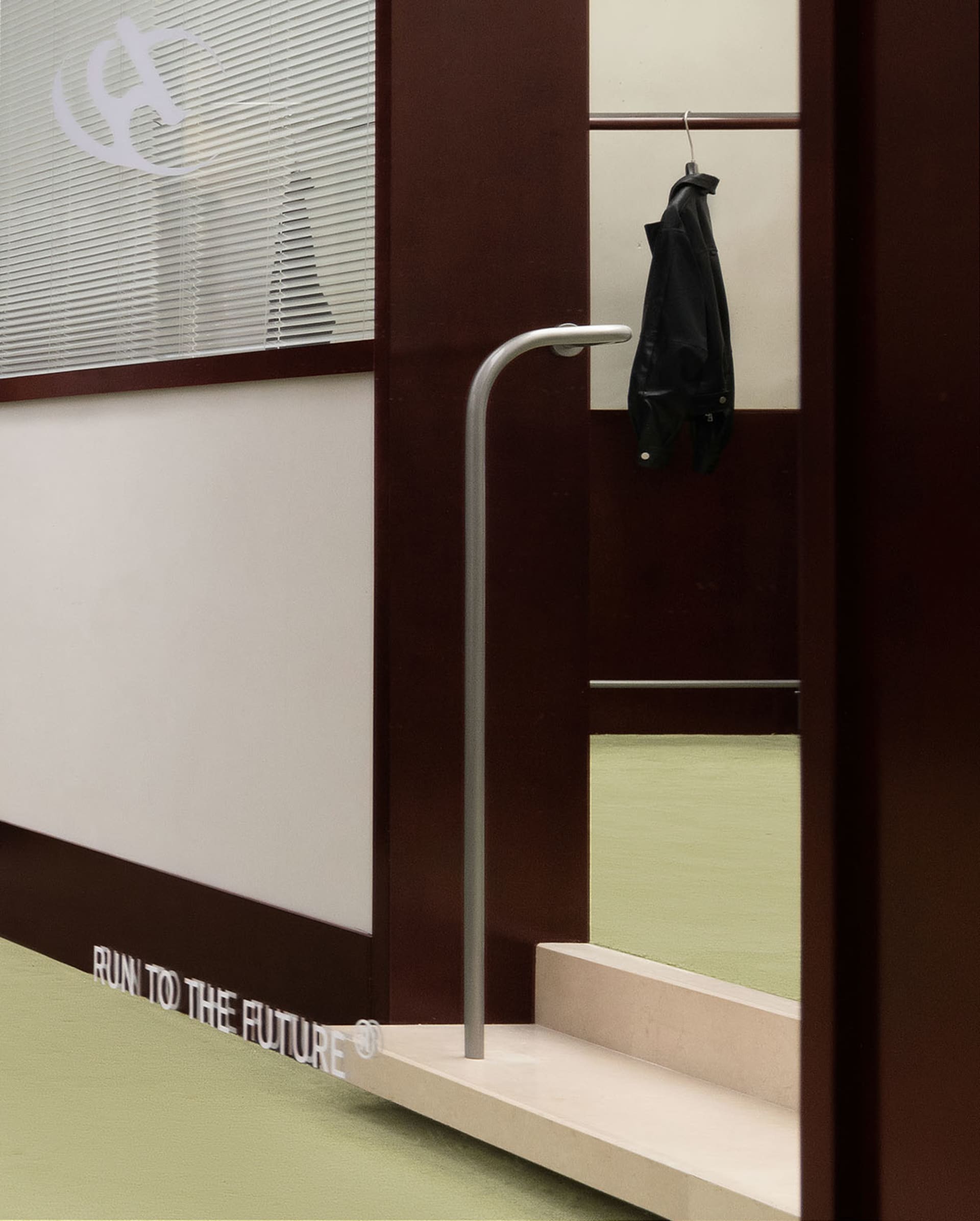 A metal clothing rack hanging in a modern industrial-style room.