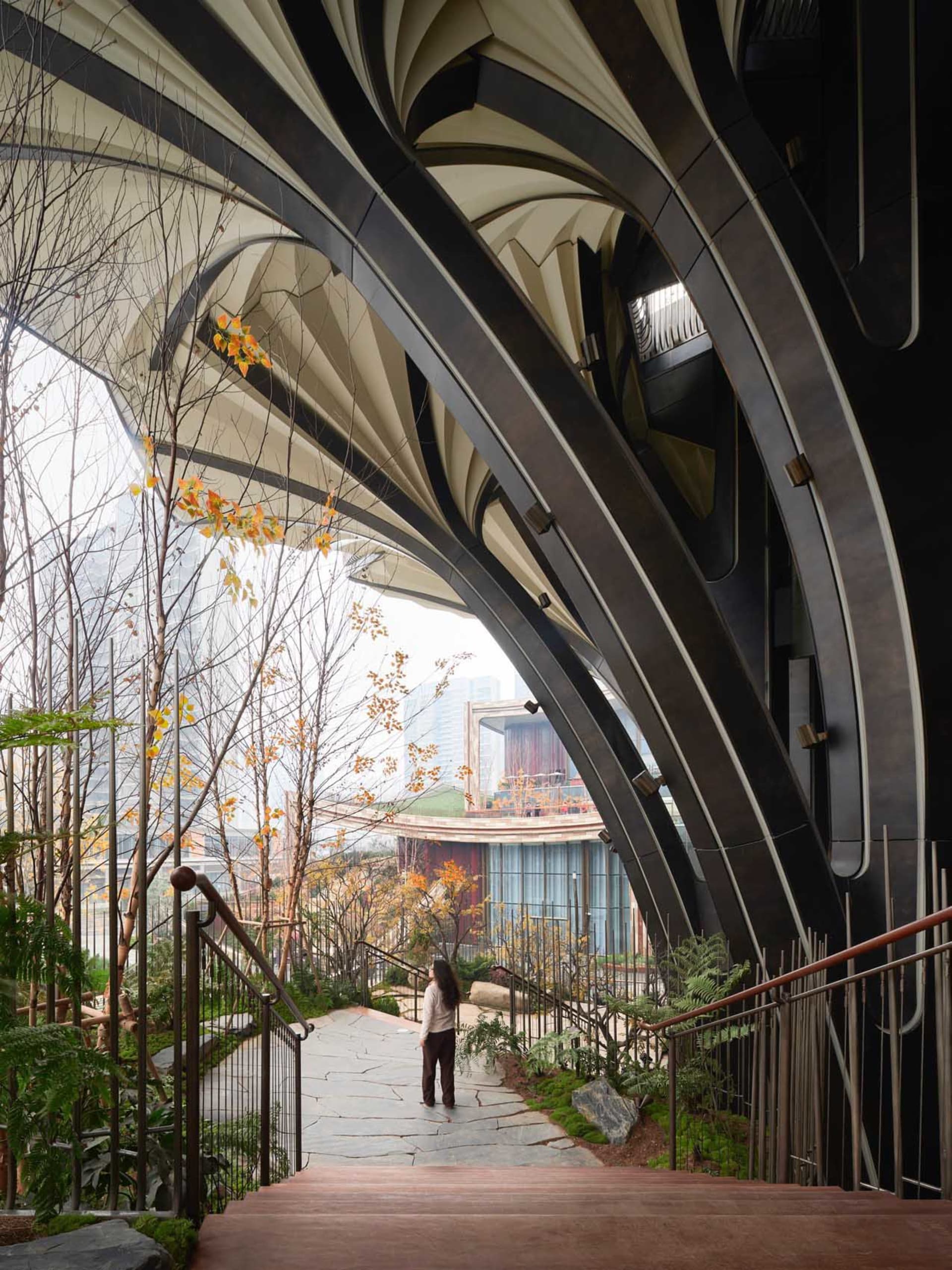 A modern architectural structure featuring large, curved metal arches.