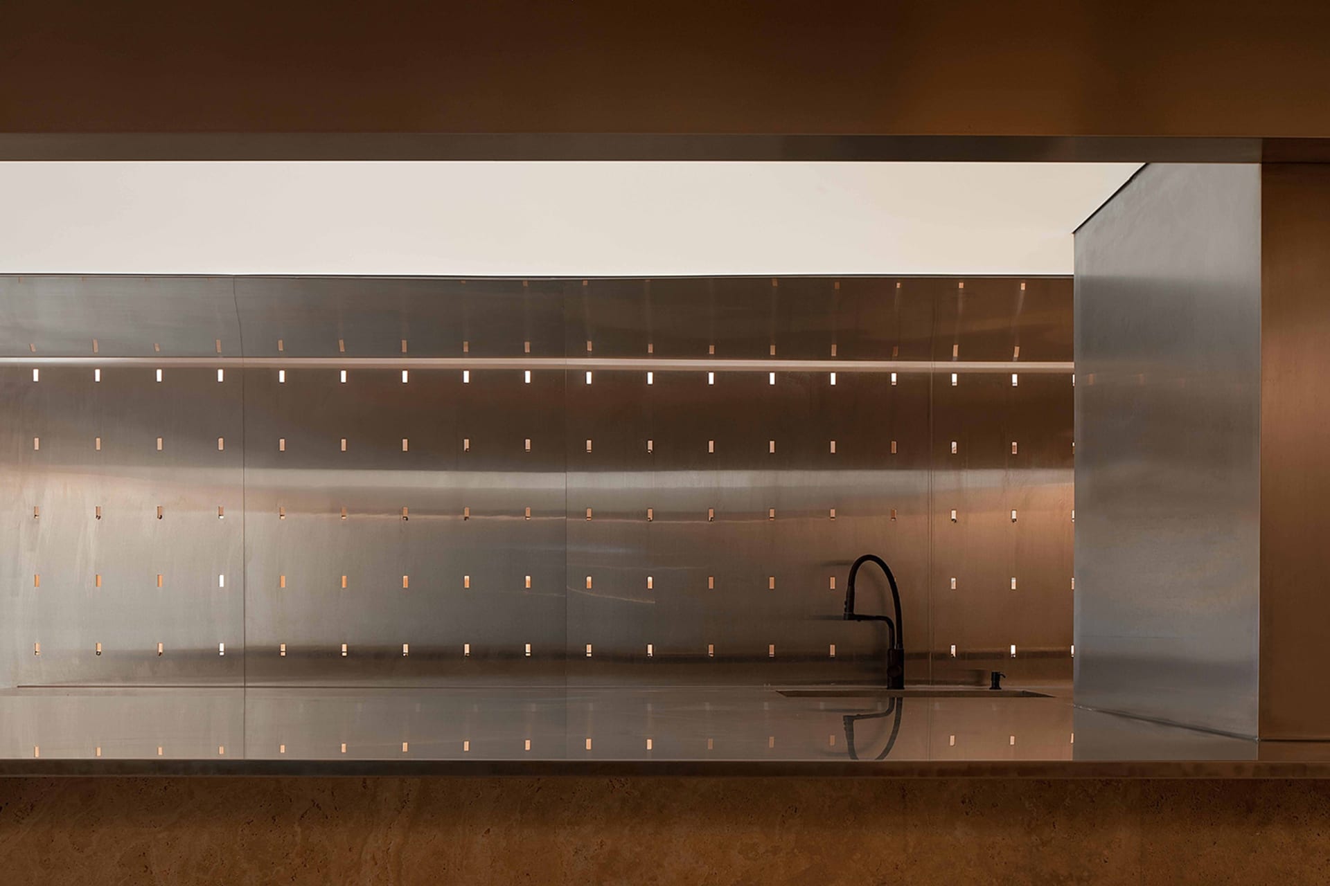 An minimalist metallic interior design with a sleek, modern aesthetic and reflective surfaces.