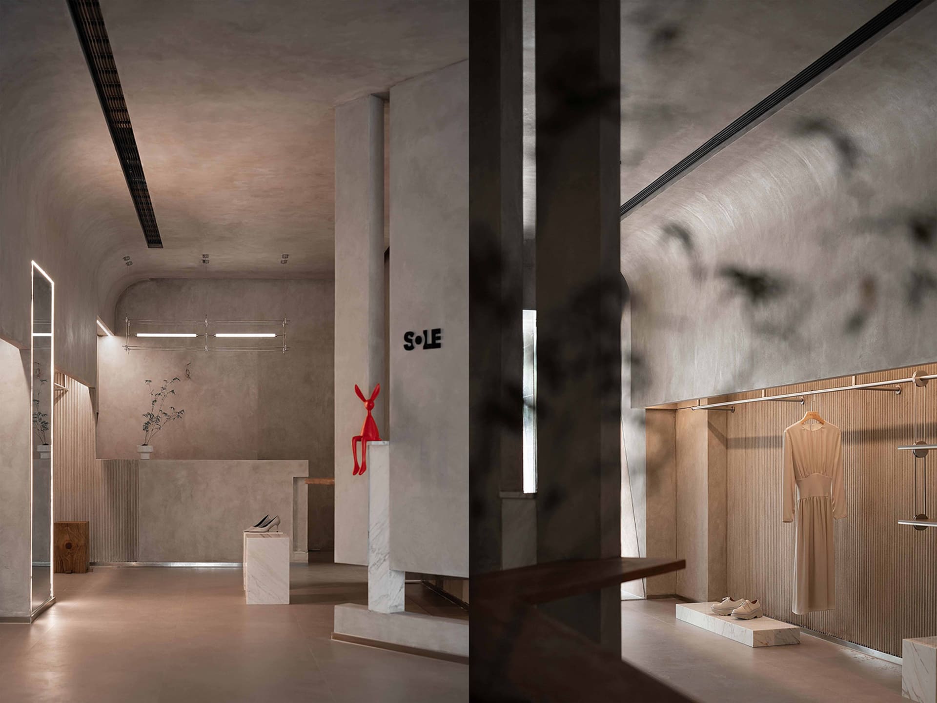 A modern retail storefront featuring concrete walls and minimalistic design.