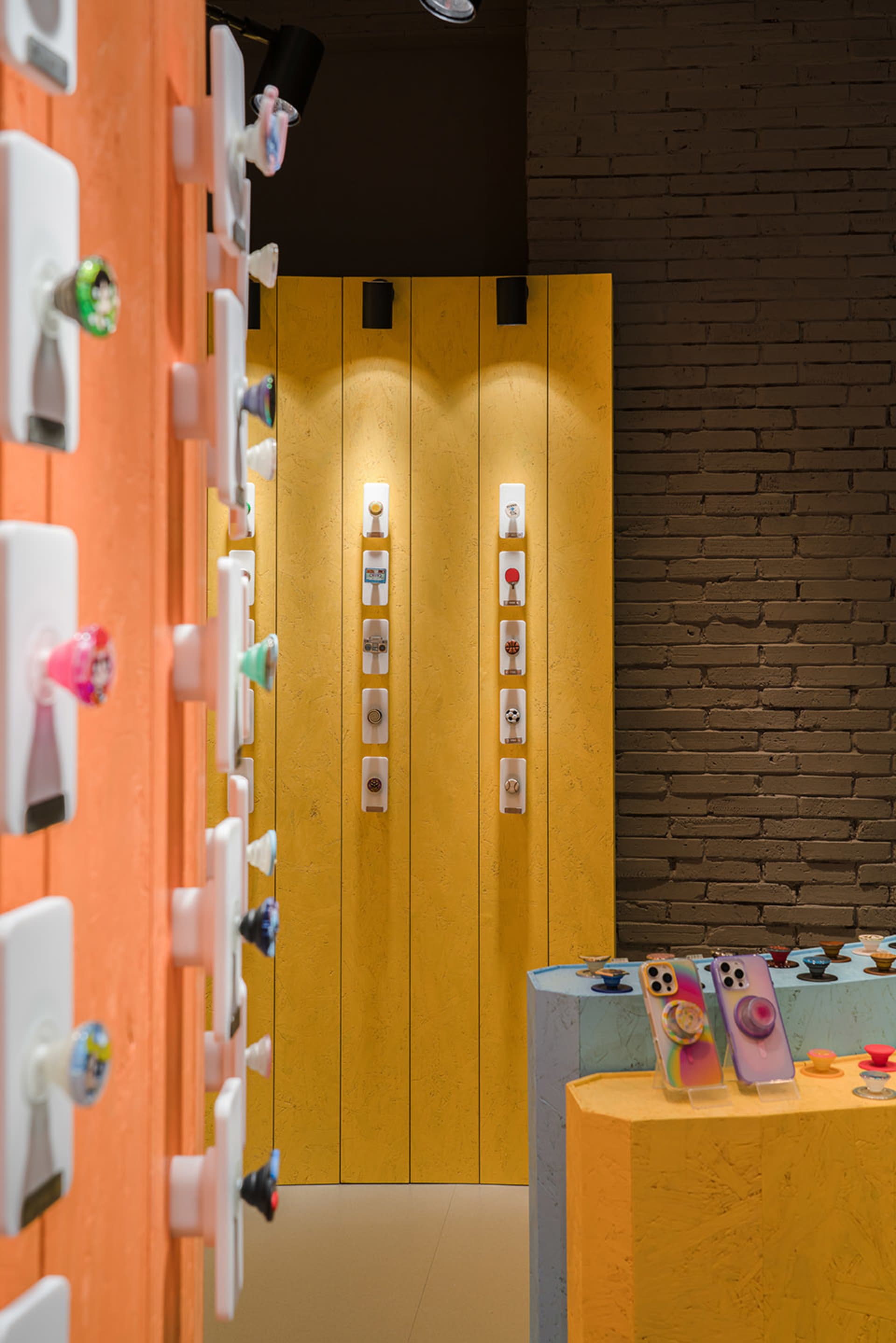 A modern storefront displaying various products such as phone cases and accessories with a vibrant design aesthetic.