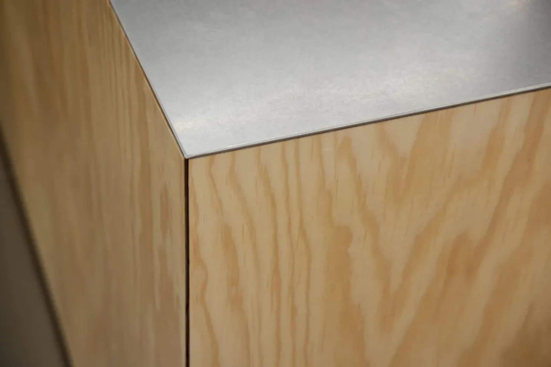 Close-up view of a wooden cabinet with a metallic countertop.