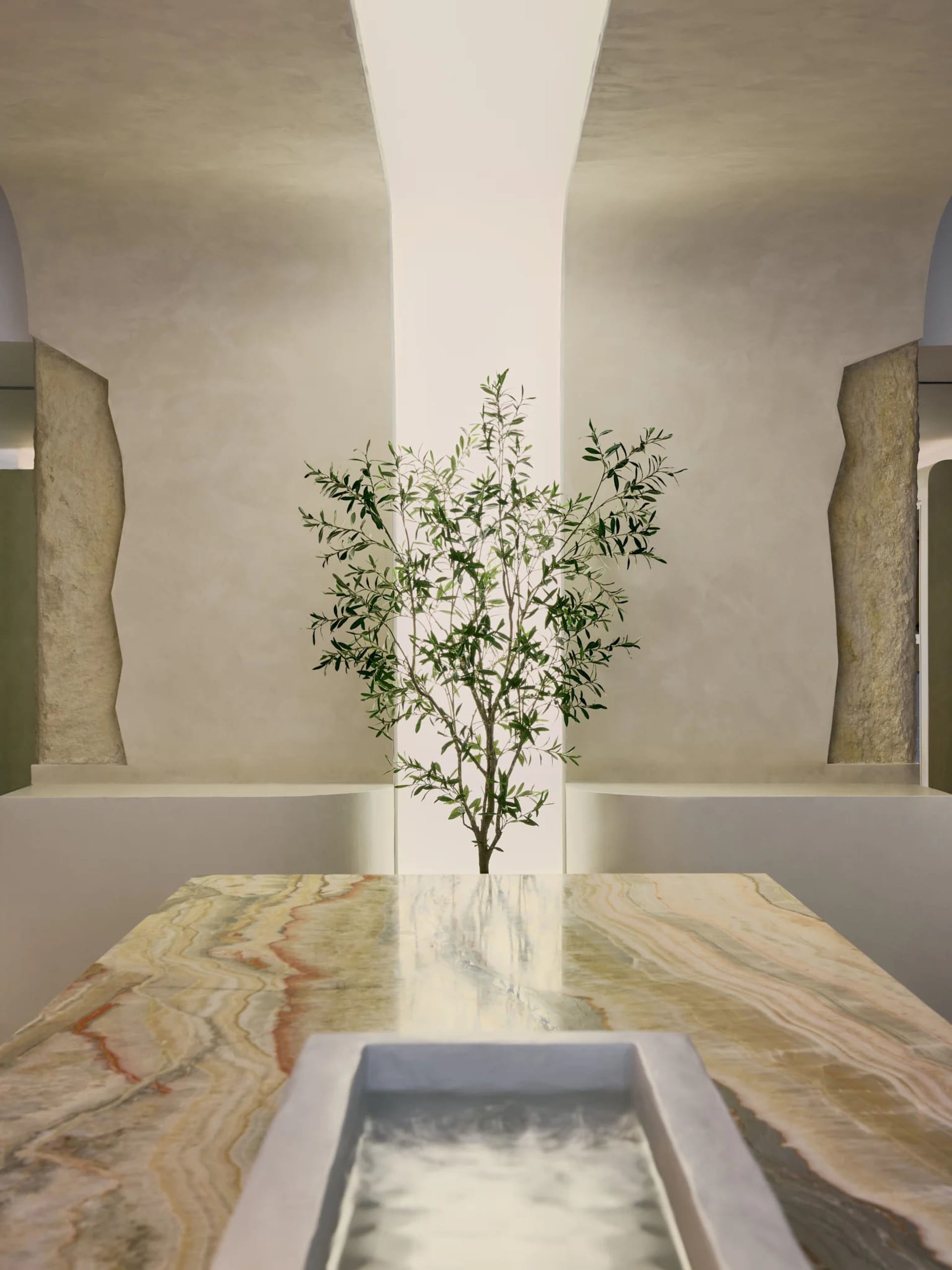 A minimalist interior design featuring marble surfaces and an olive tree
