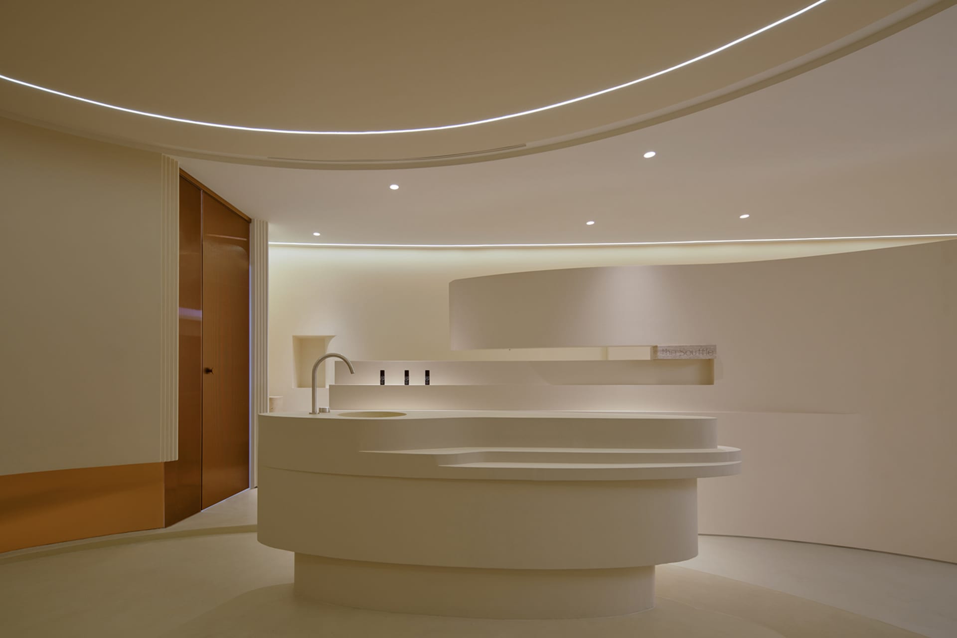 Modern minimalist white reception area with sleek furniture and lighting